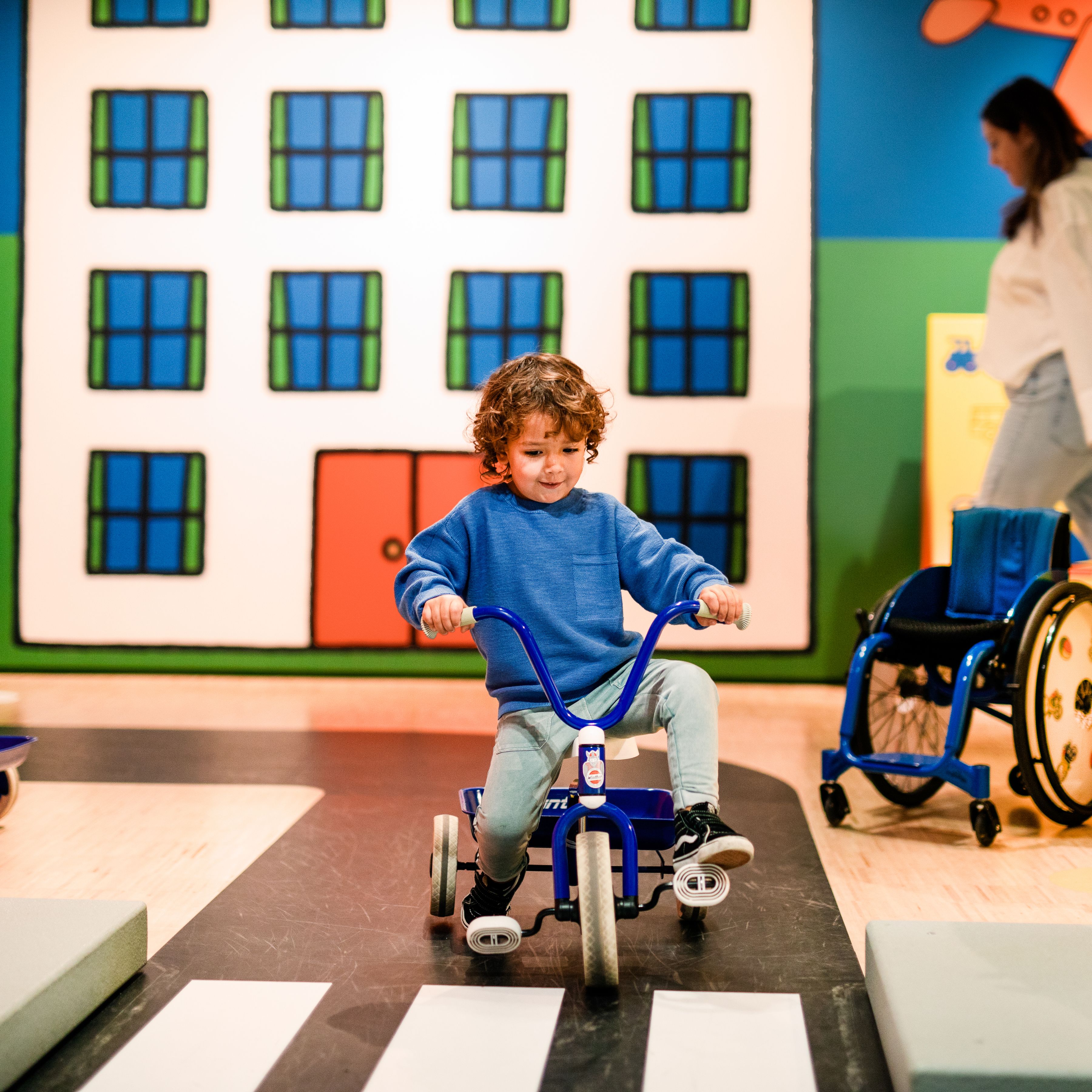 Child on a tricycle at the traffic square in the Miffy Museum