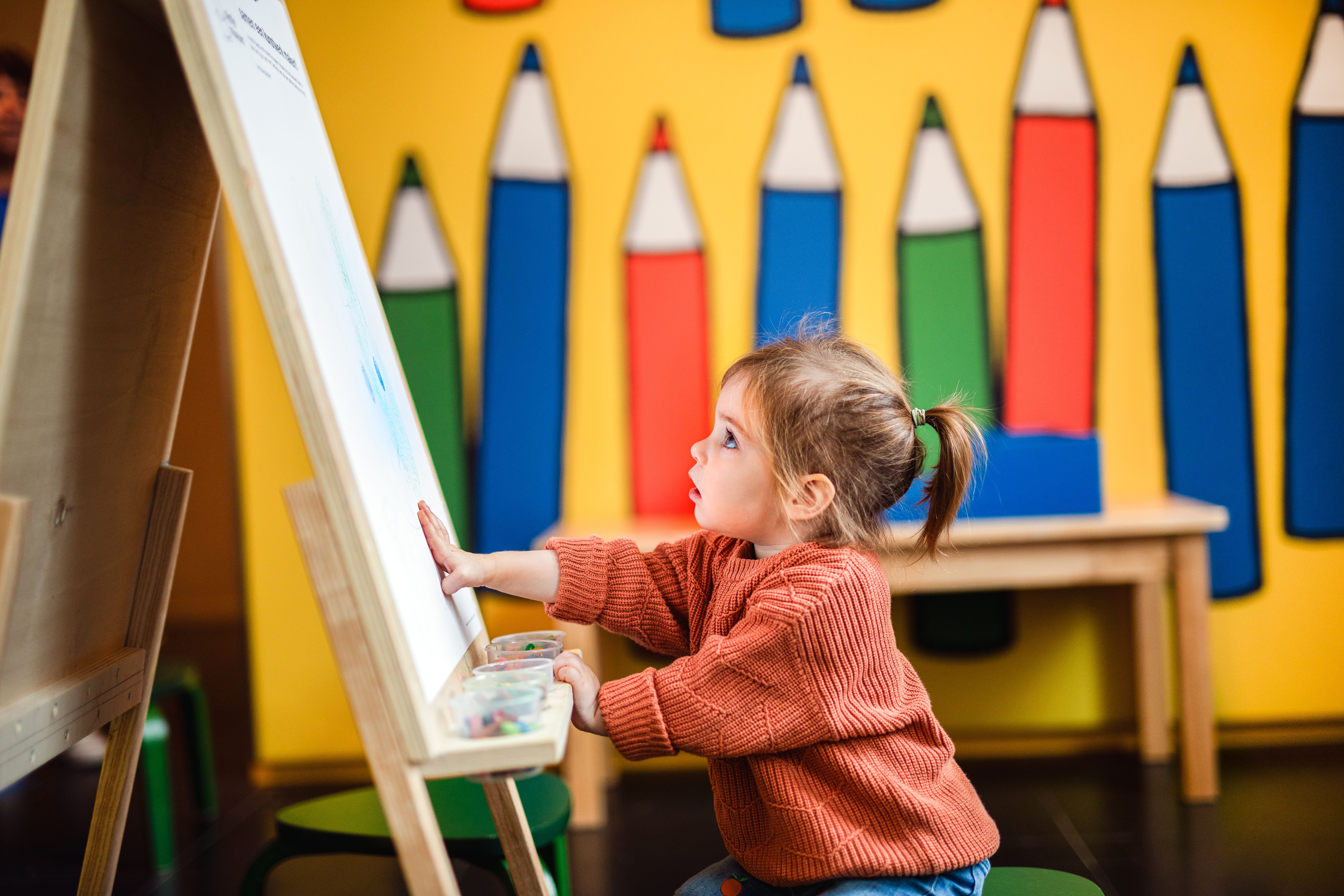 child drawing in art room