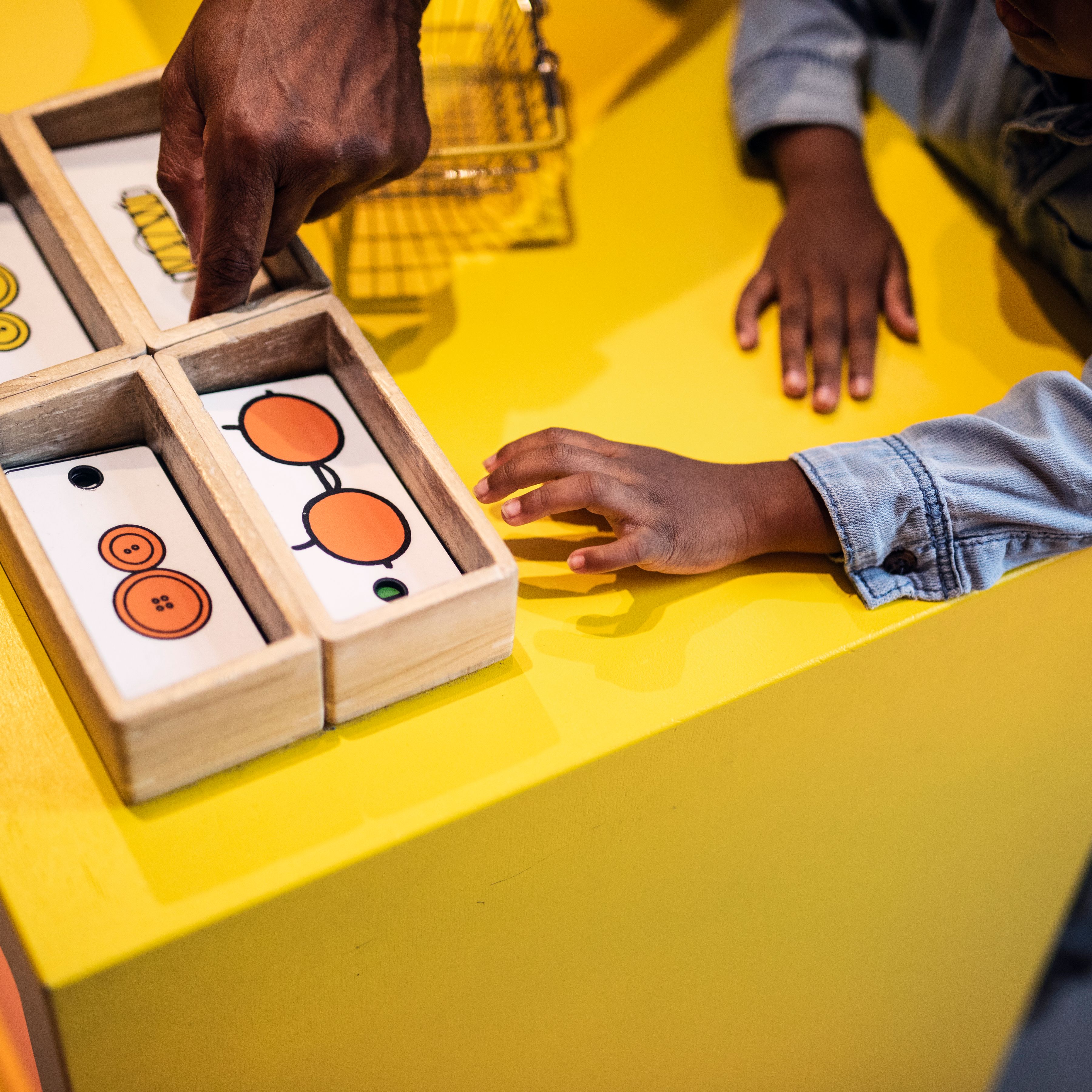hands on yellow counter in Poppy pig's shop