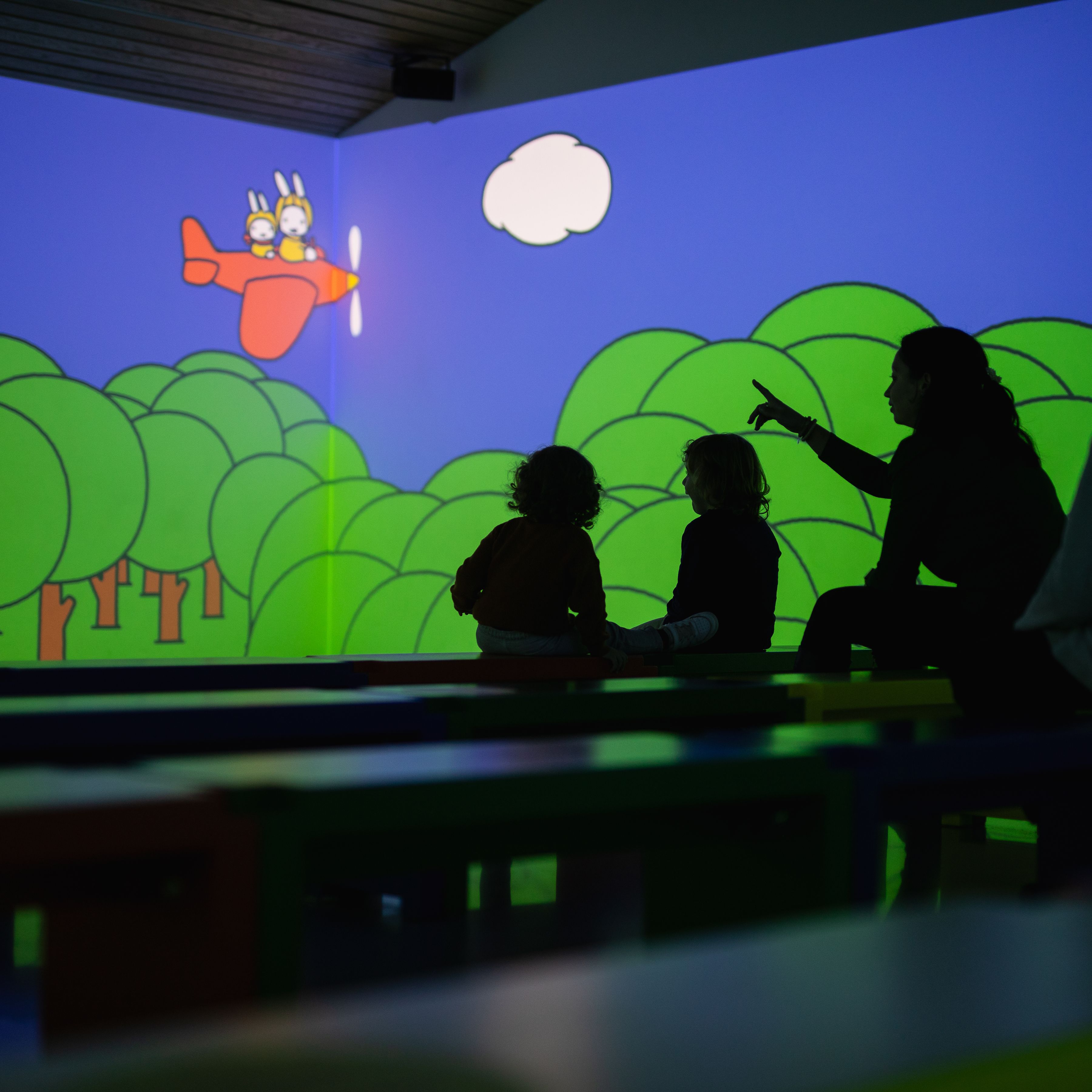 Children and adults looking at projection