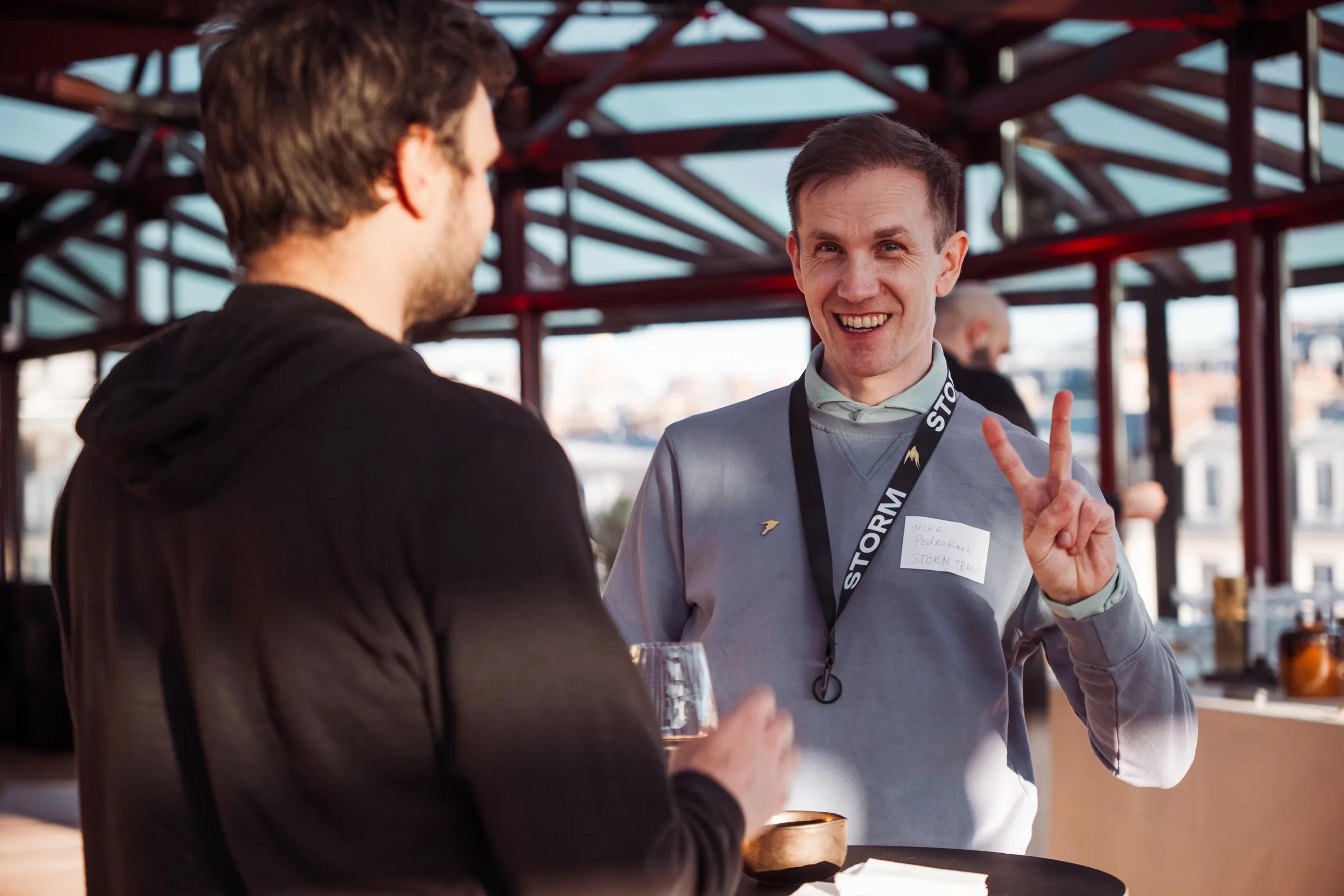 A guest smiling mid-conversation at the dYdX rooftop event
