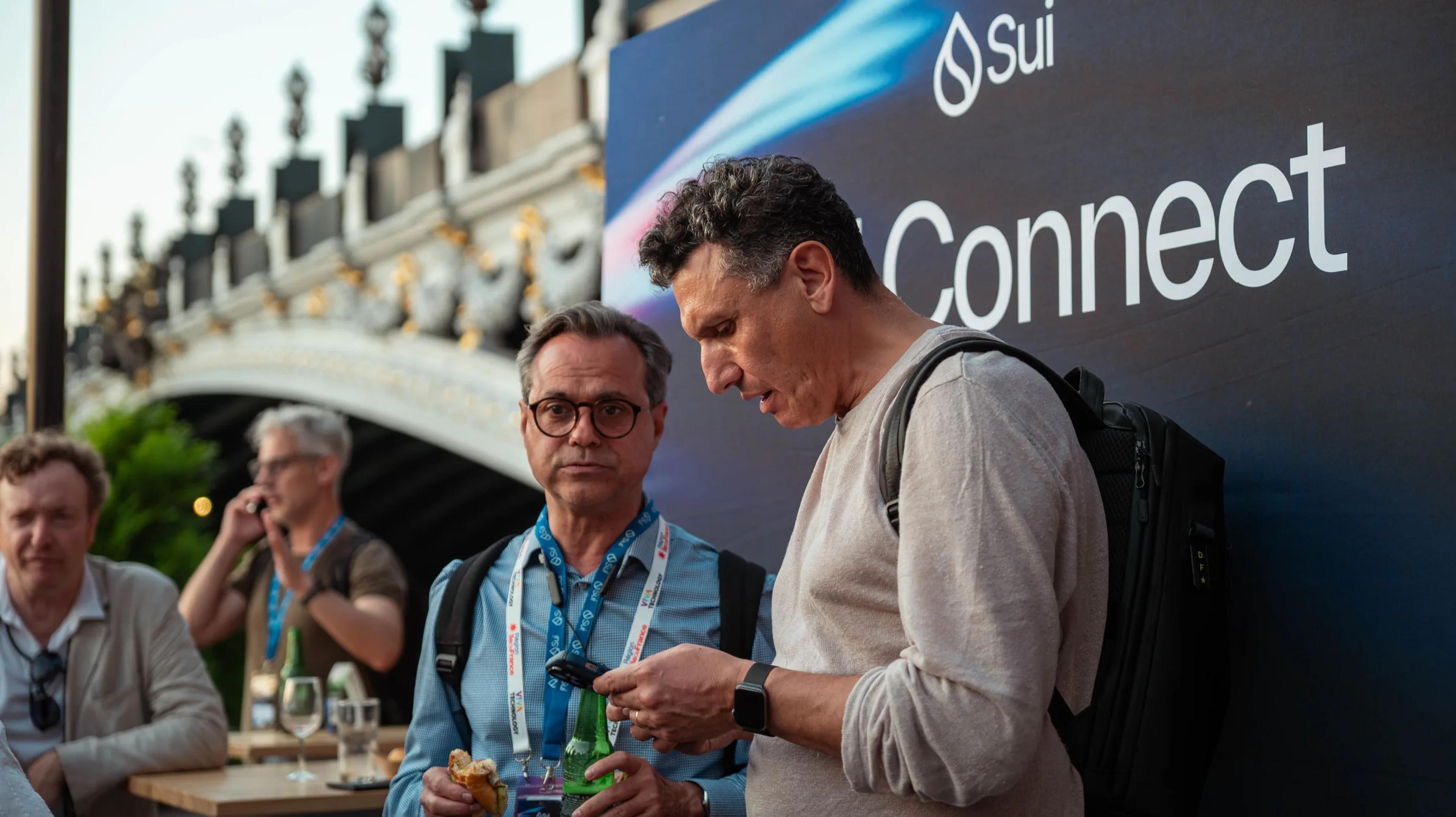 Attendees in front of a Sui Connect banner on the terrace