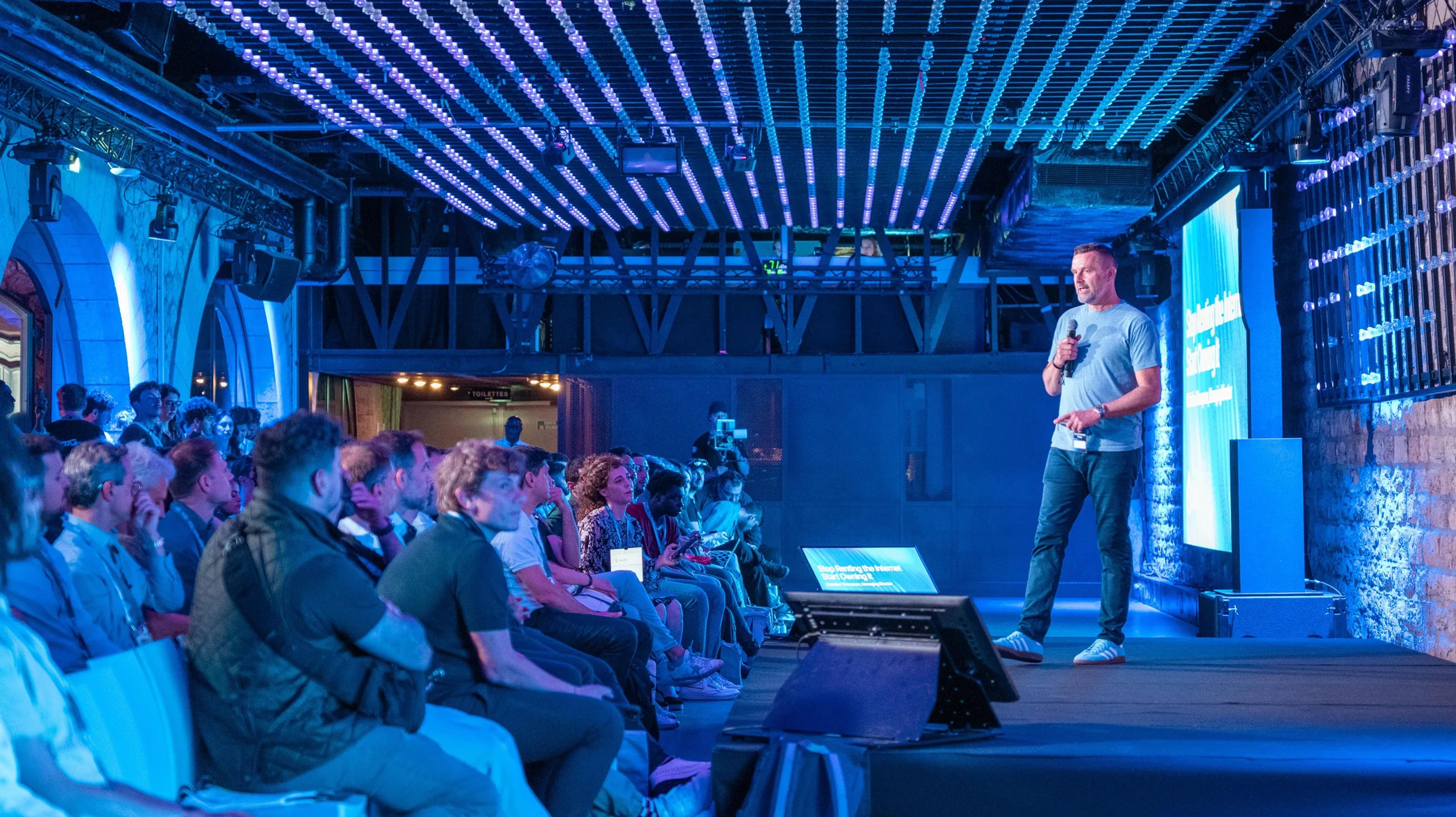 A wide view of the stage and the seated audience at Sui Connect Paris