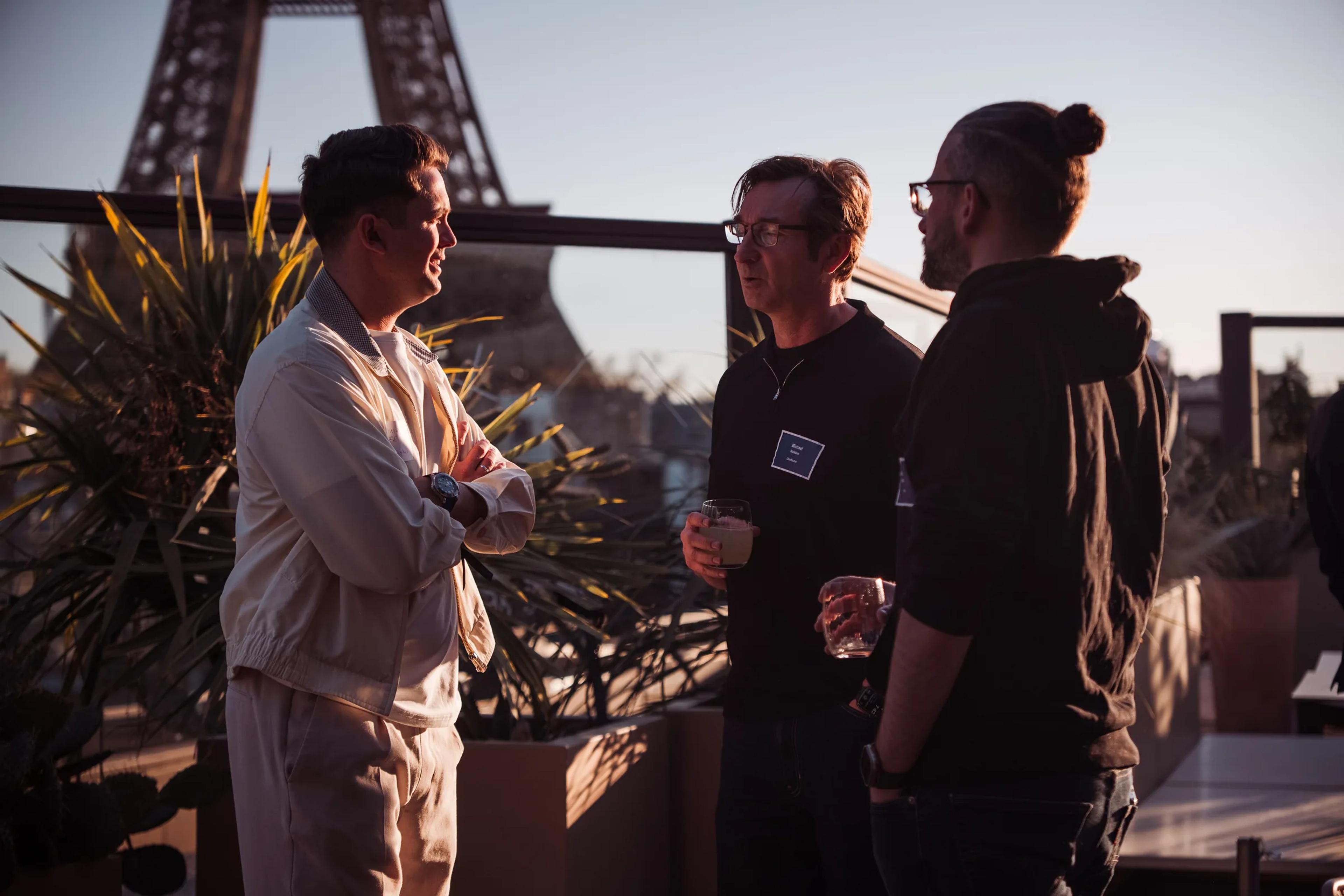 Guests talking with the Eiffel Tower behind them