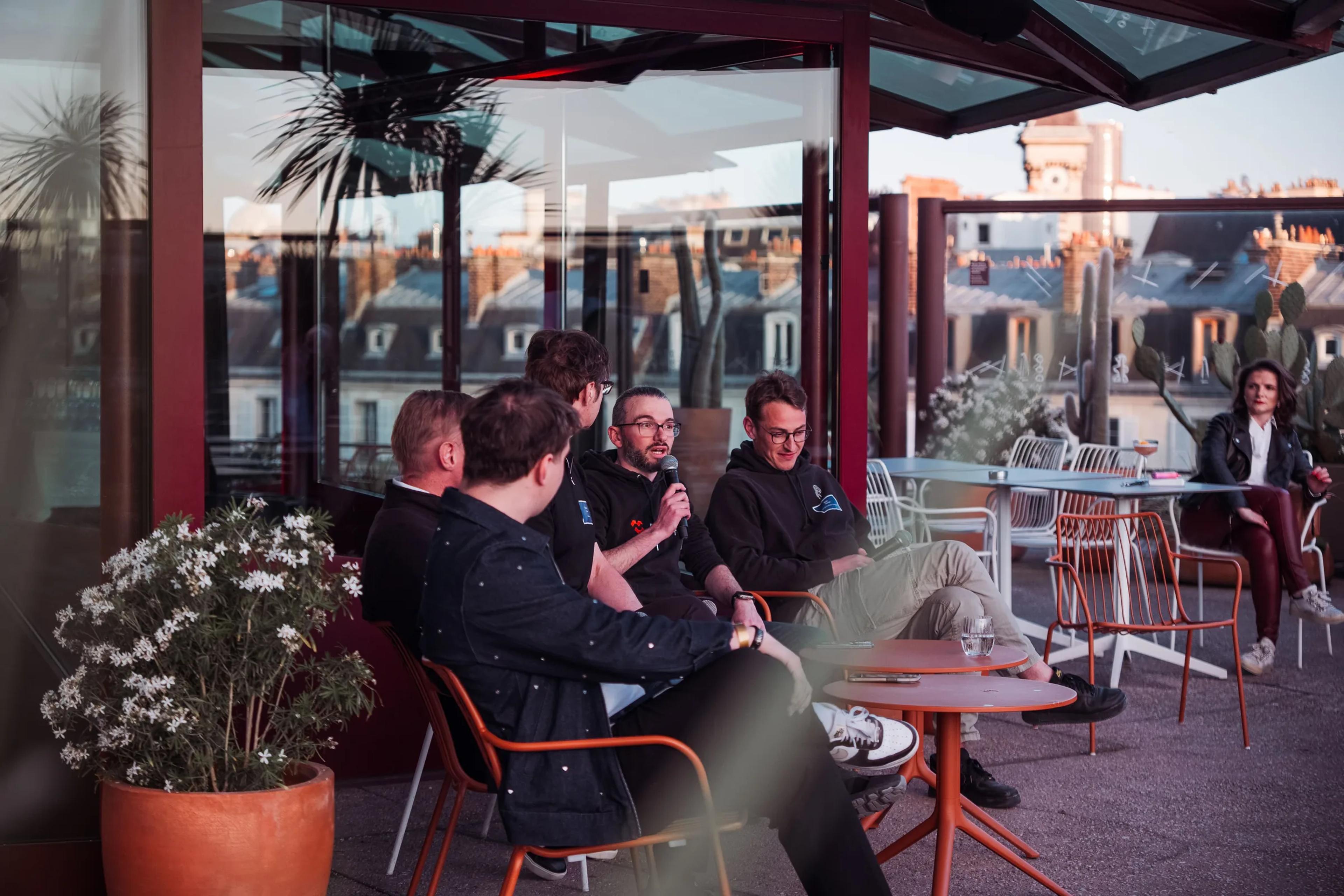 Guests seated in conversation on the rooftop terrace
