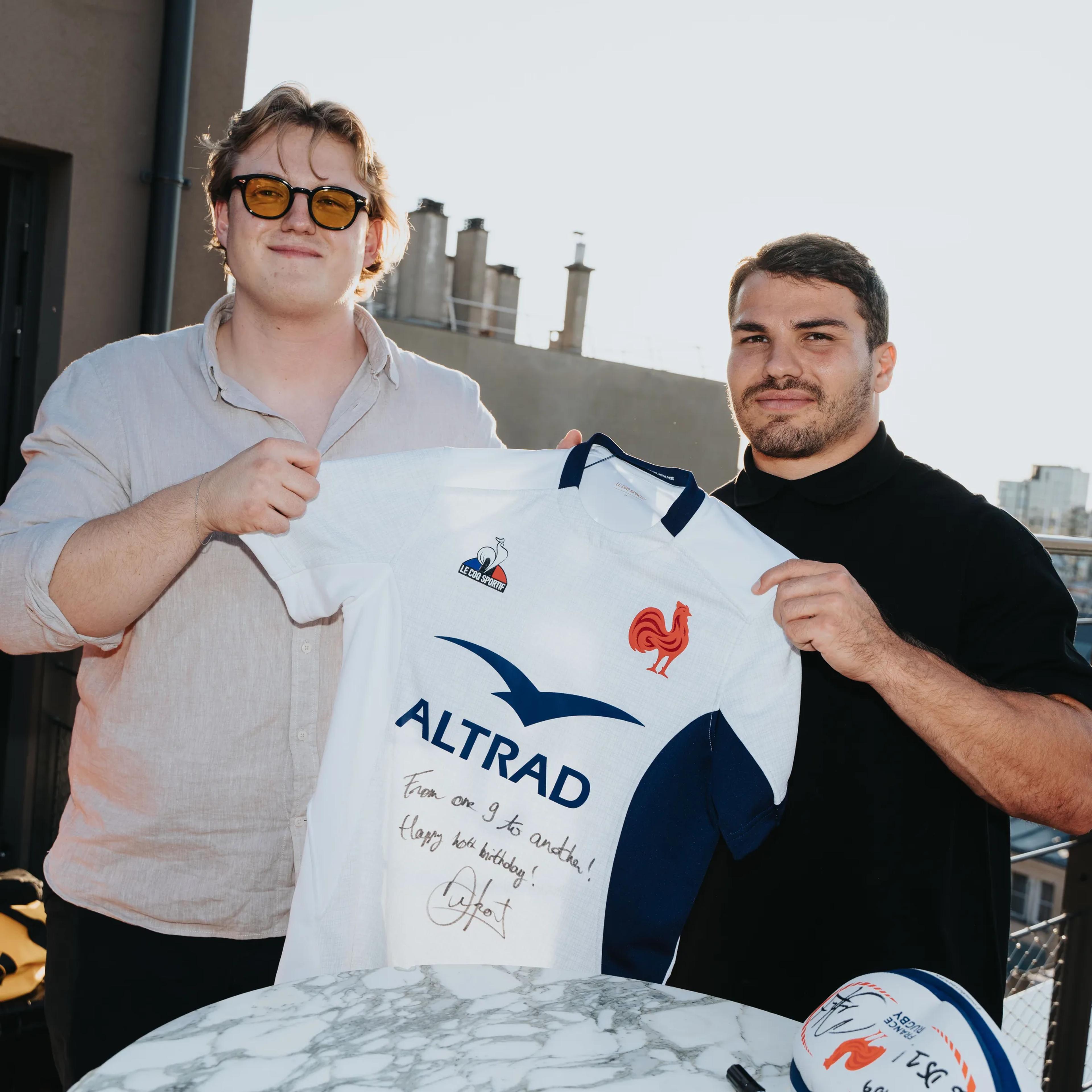 Guests holding a signed French rugby jersey at the Bitpanda event