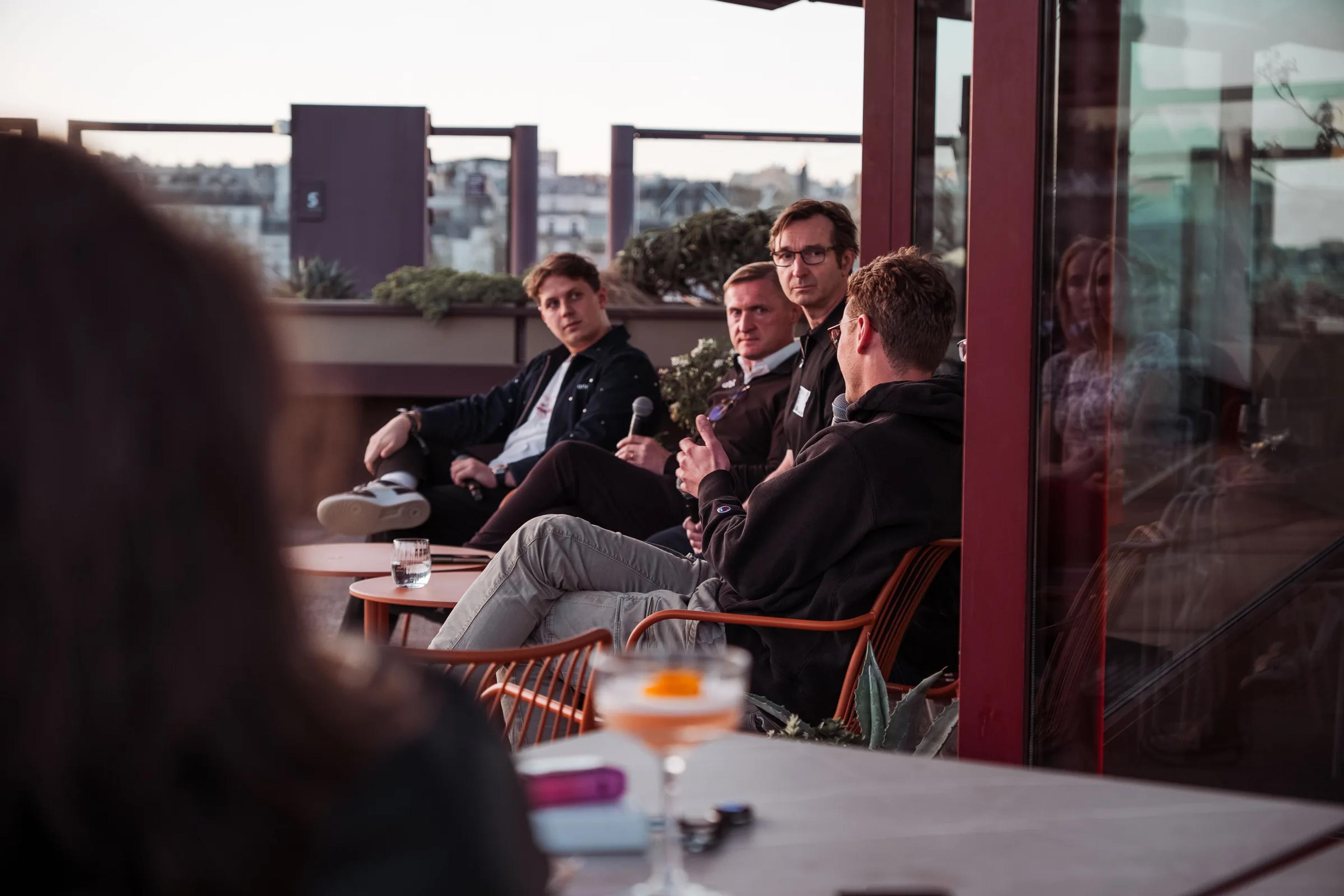 Guests seated around tables as the evening session begins