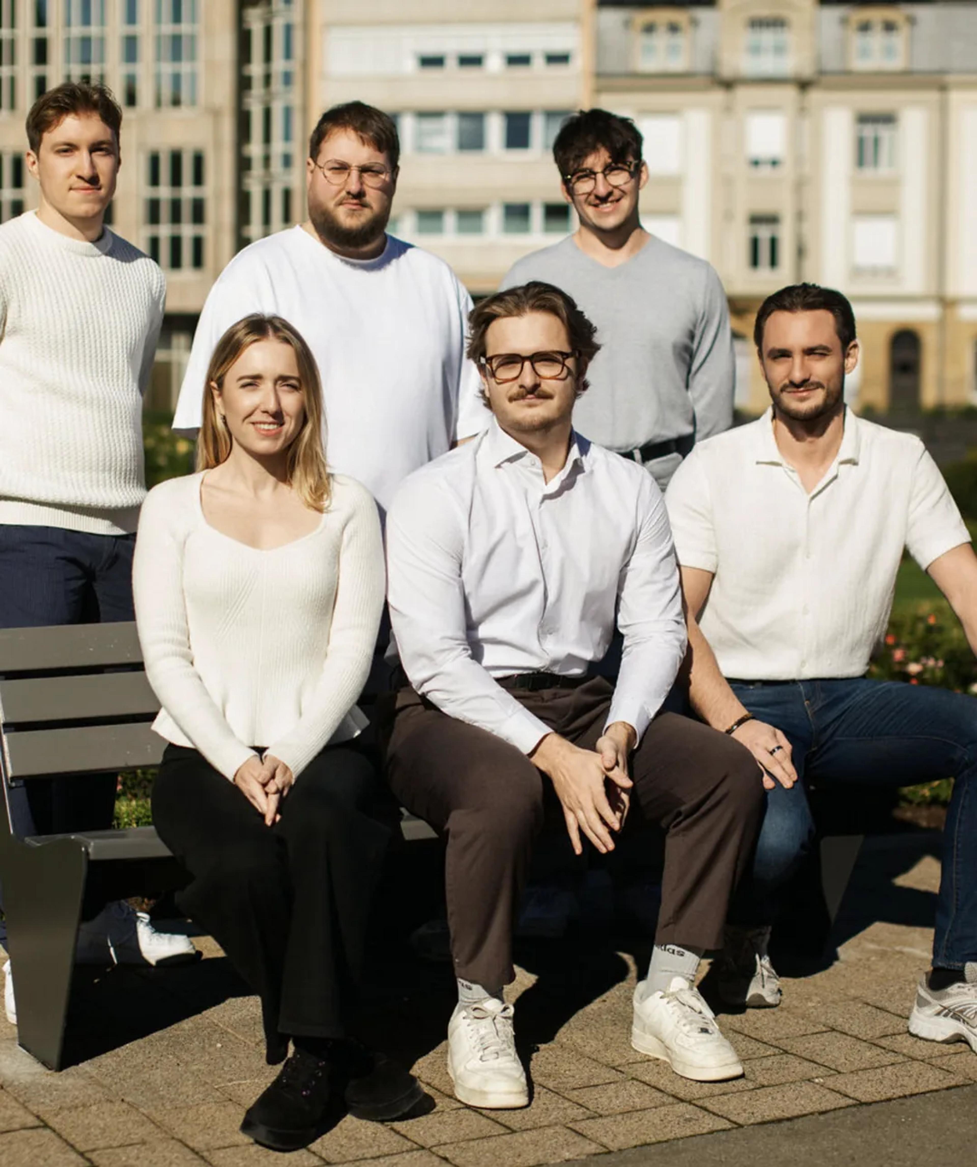 The Hash Consulting team gathered around a park bench in the sun.