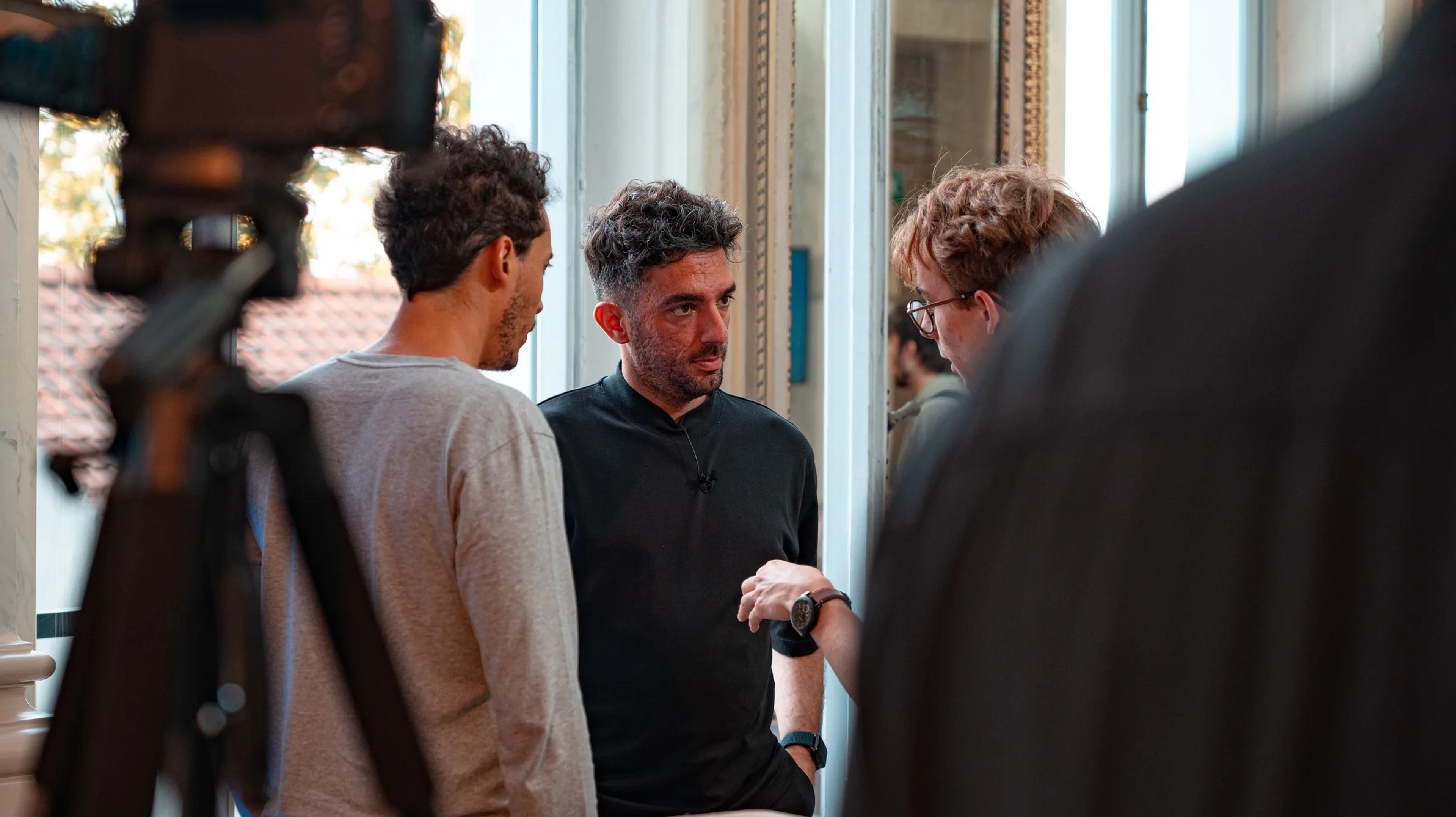 A camera rig filming attendees in conversation
