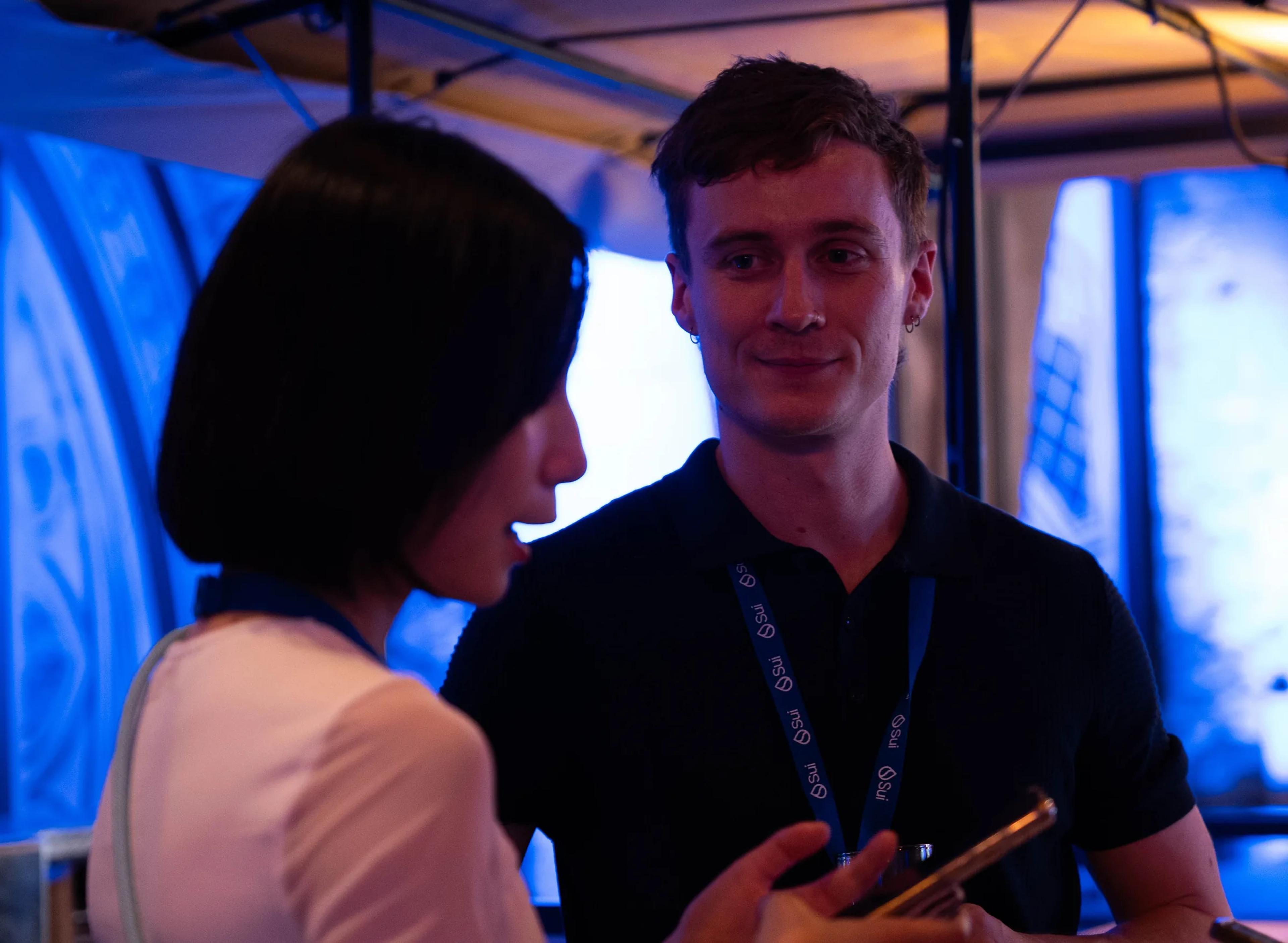 Two attendees in conversation at Sui Connect Paris
