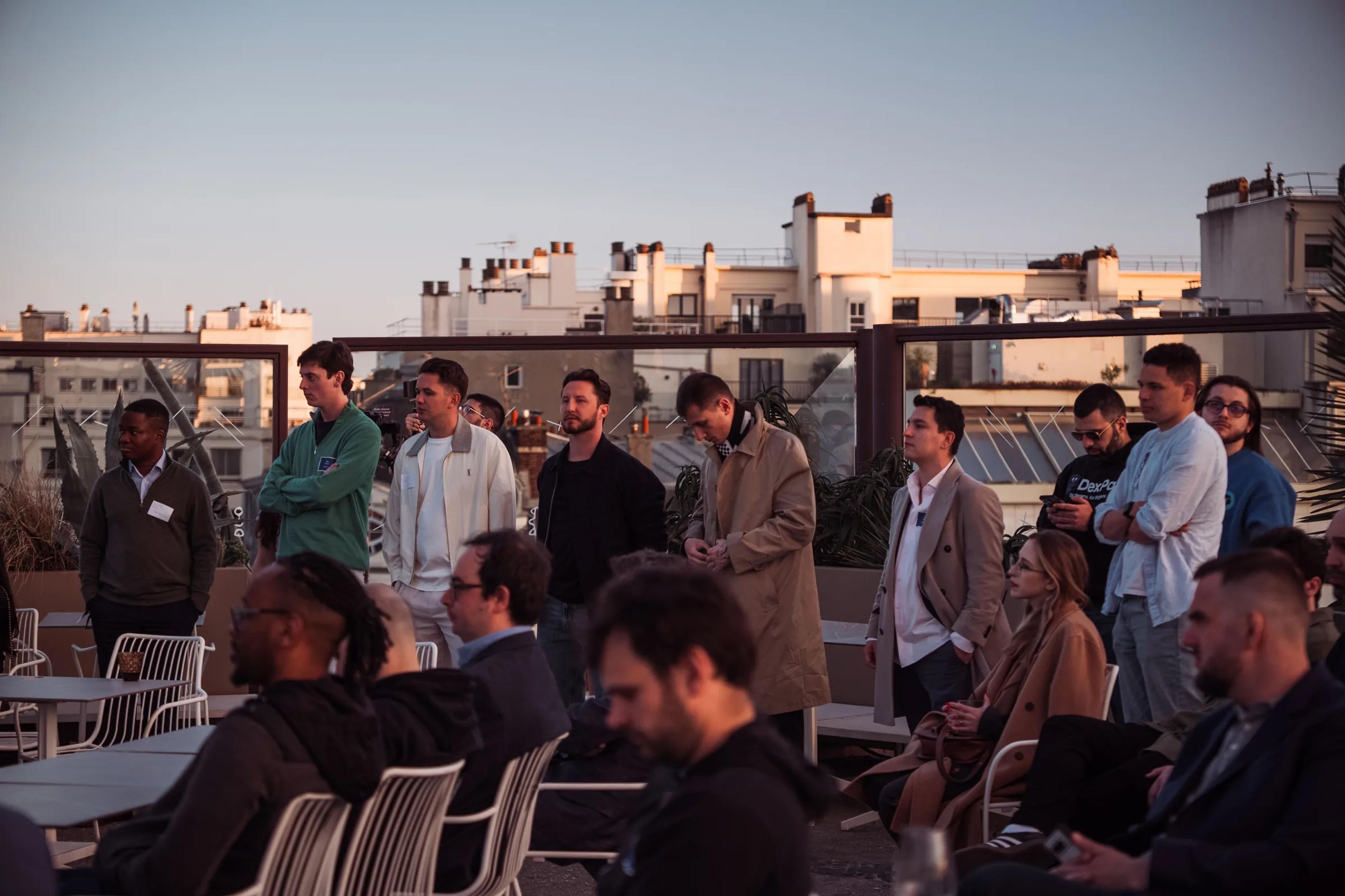 Guests gathered on the rooftop terrace overlooking Paris