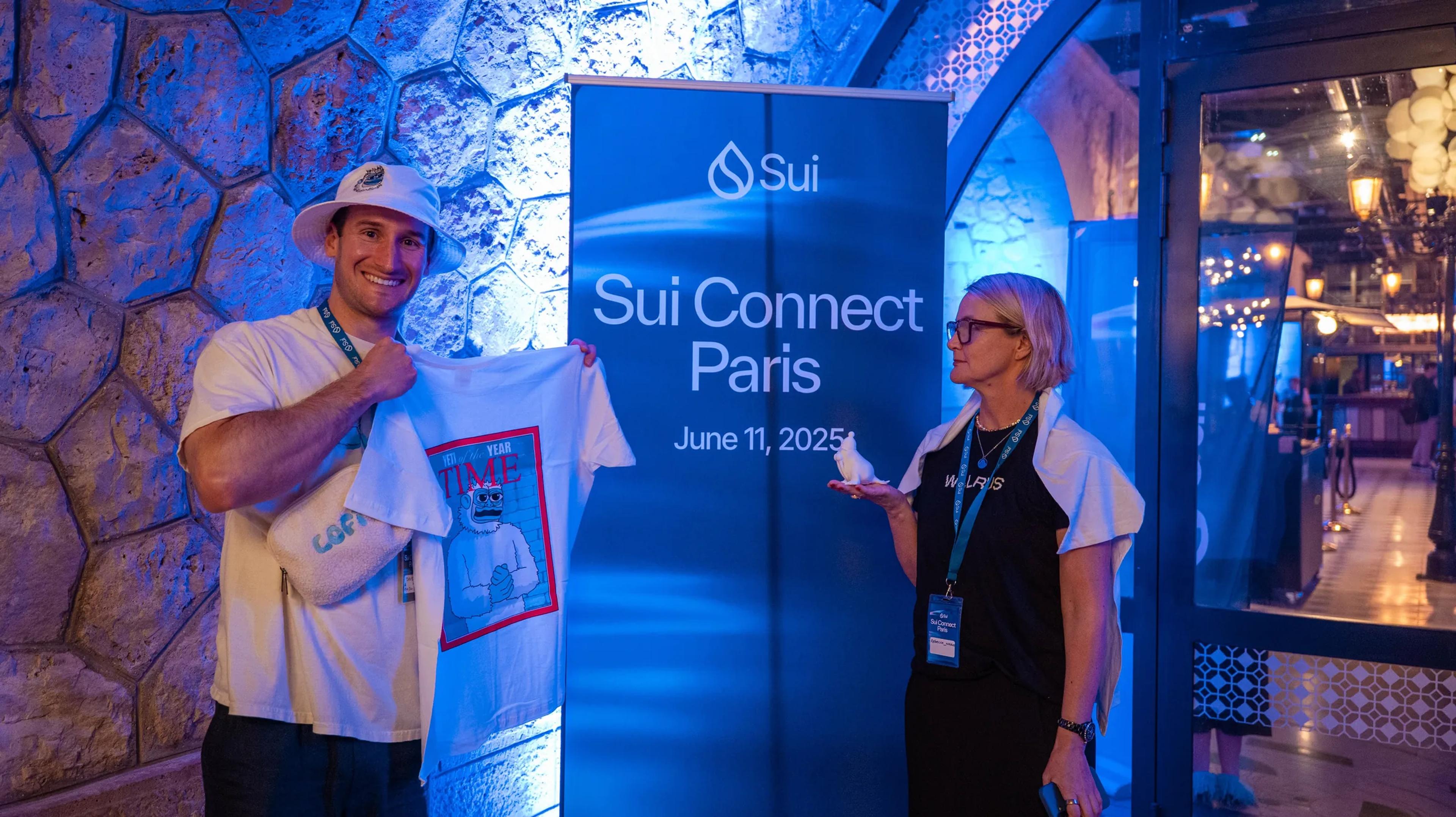 Guests posing with the Sui Connect Paris banner