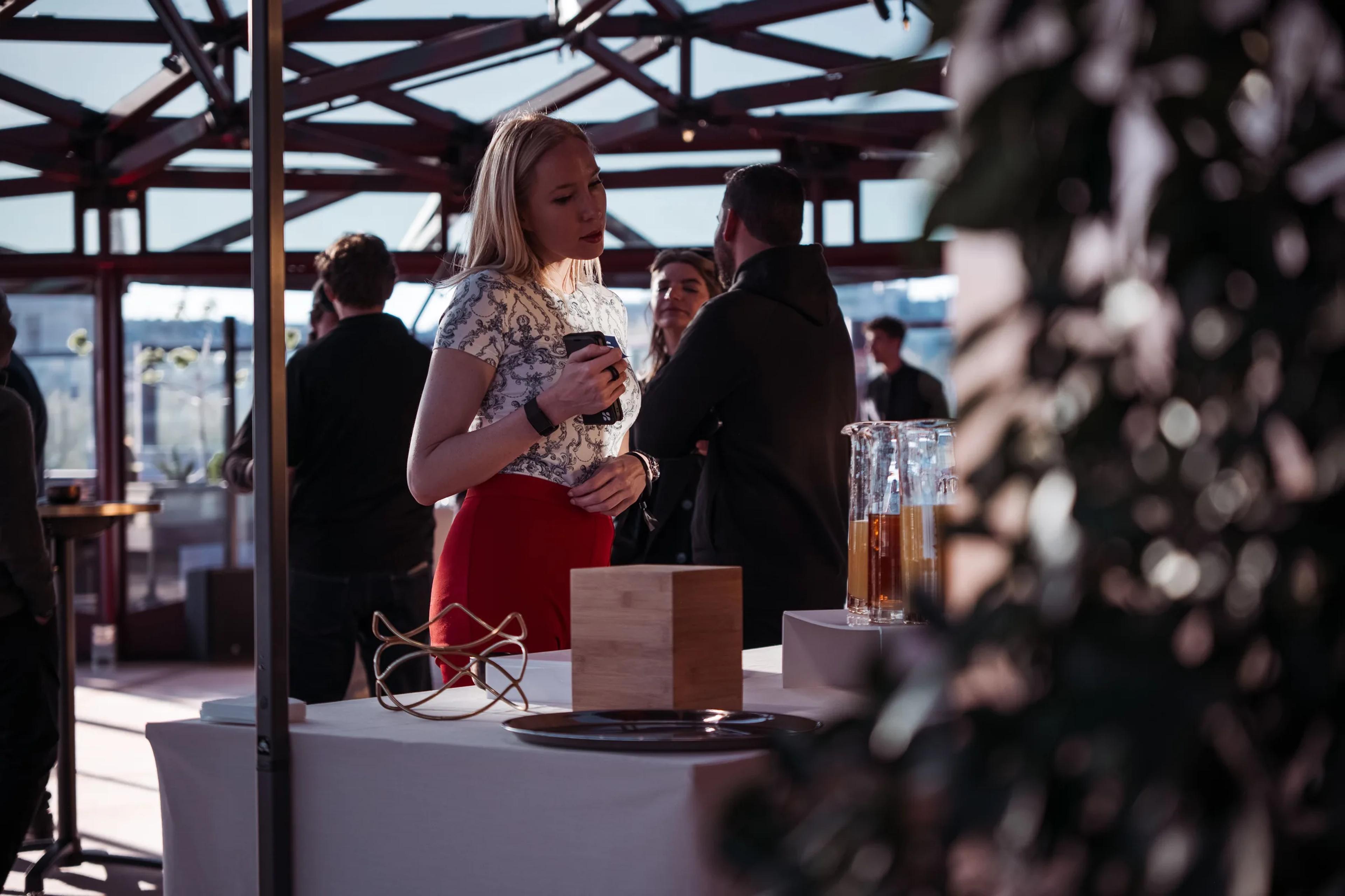 Guests chatting under the rooftop's steel canopy