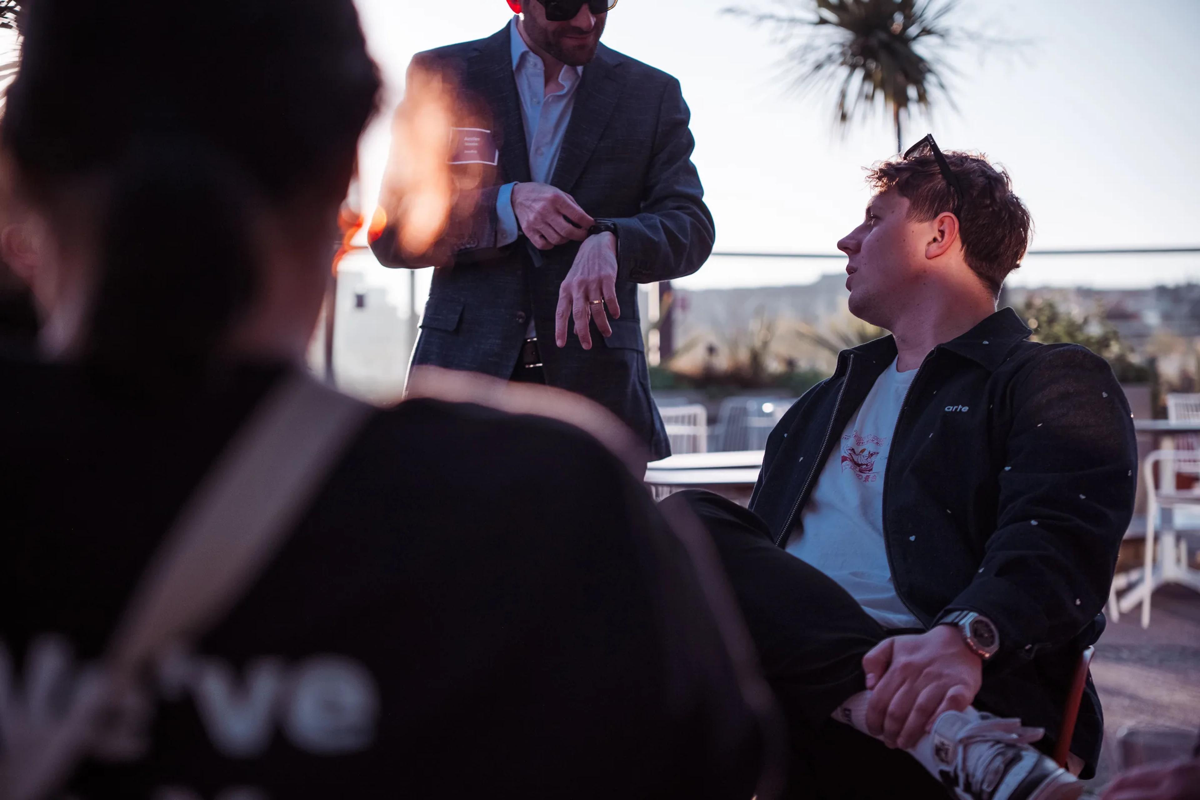 A guest listening during a rooftop conversation