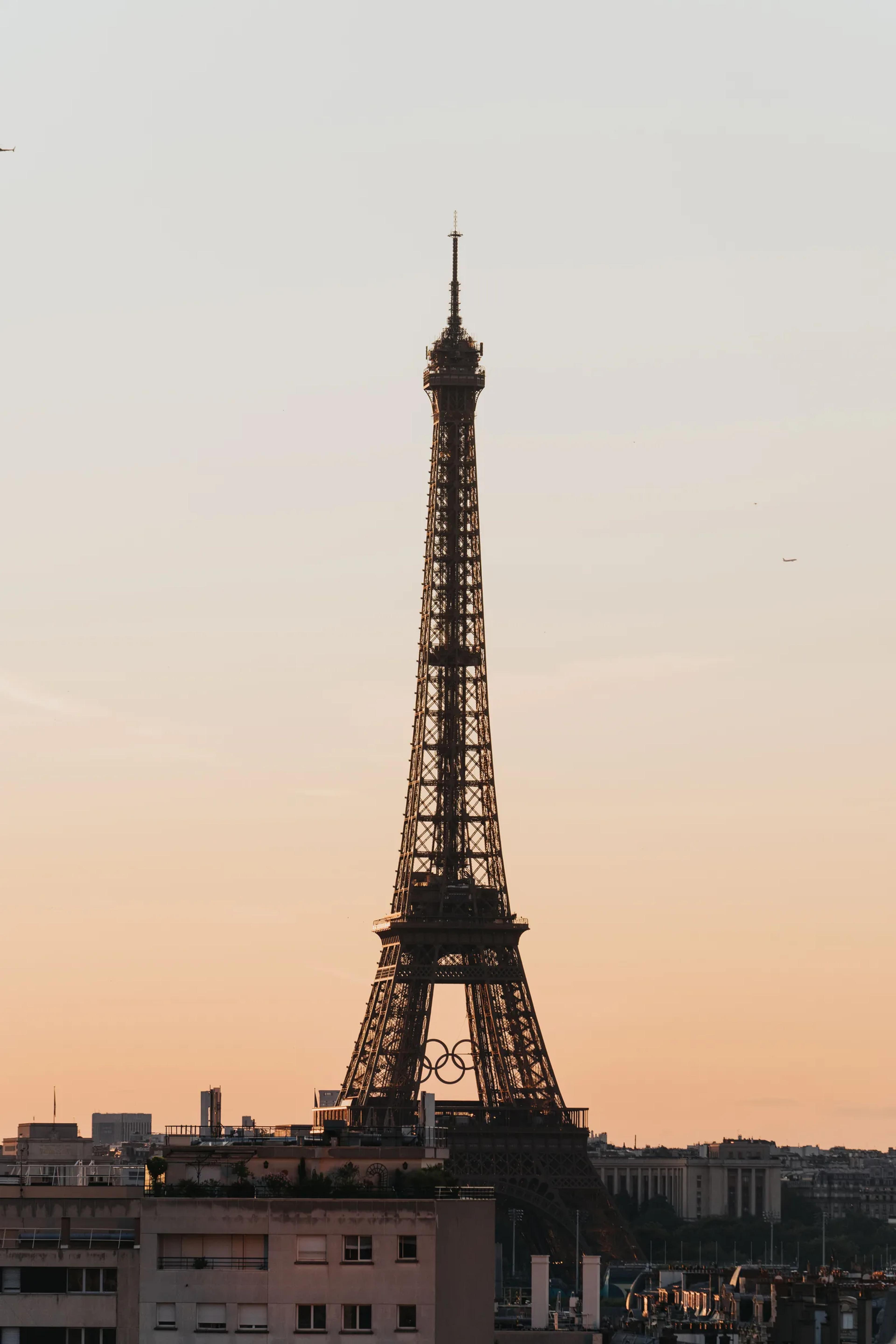 The Eiffel Tower silhouetted against a sunset sky
