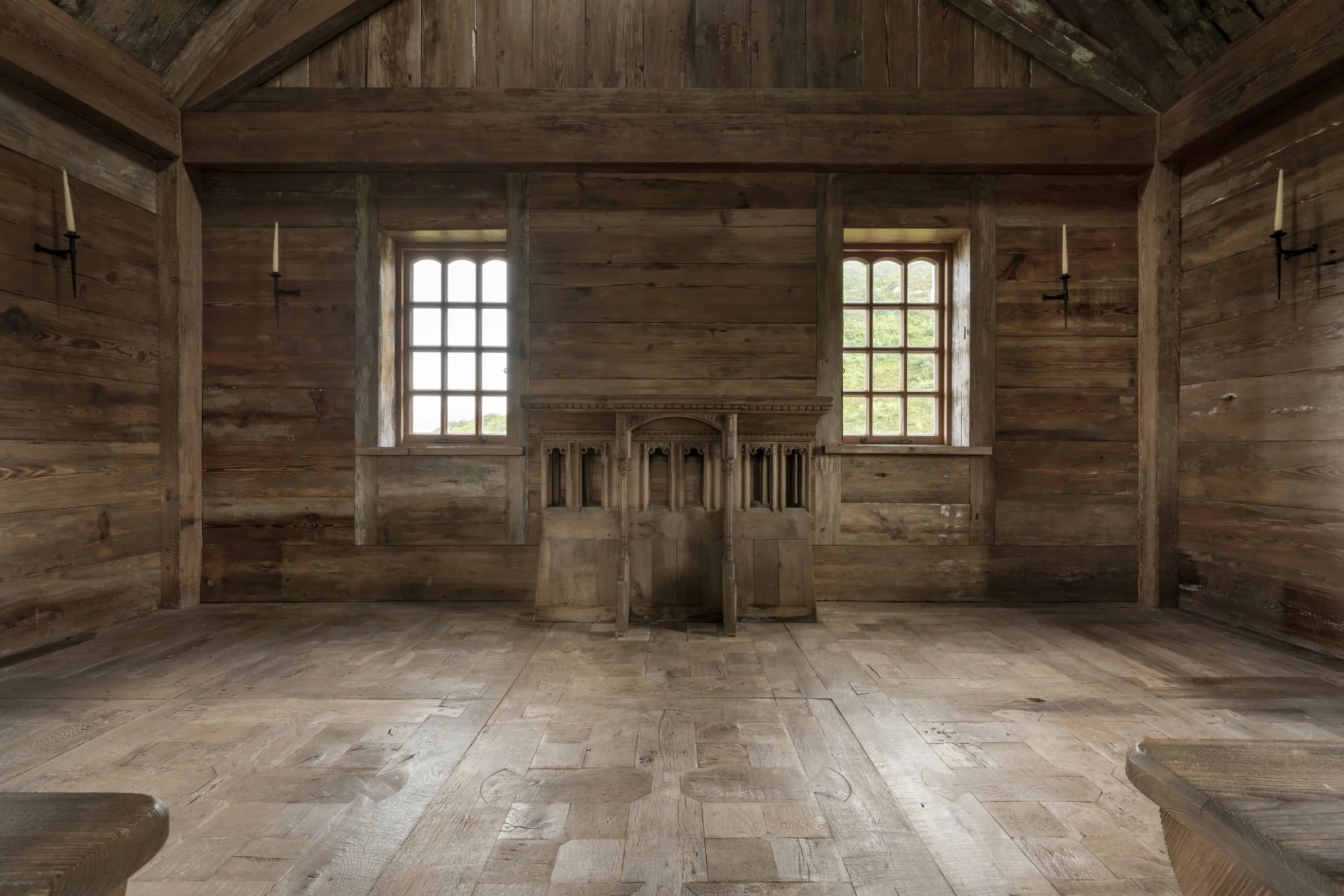 Woodworks’ expertise found its fullest expression in the floor. Inspired by a Pugin altar piece in the island’s central meeting house, the design was handmade in the Woodworks Cheshire workshops. Antique oak was carefully restored and assembled into interlocking sections, secured with over 3,000 wooden pegs. No modern finishes were applied, only the original patina of the reclaimed wood was revealed.