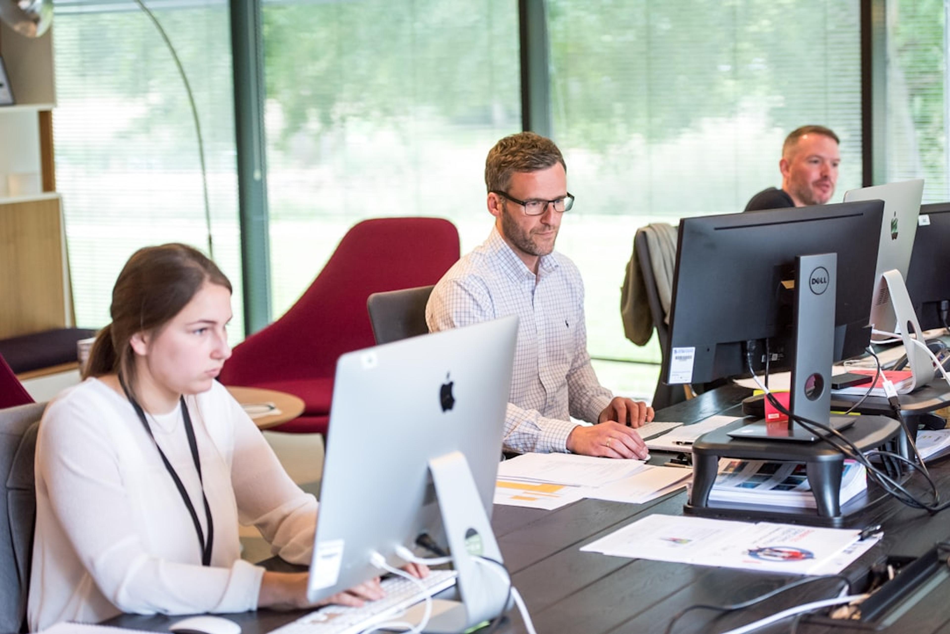 Business communications team using headsets in an office