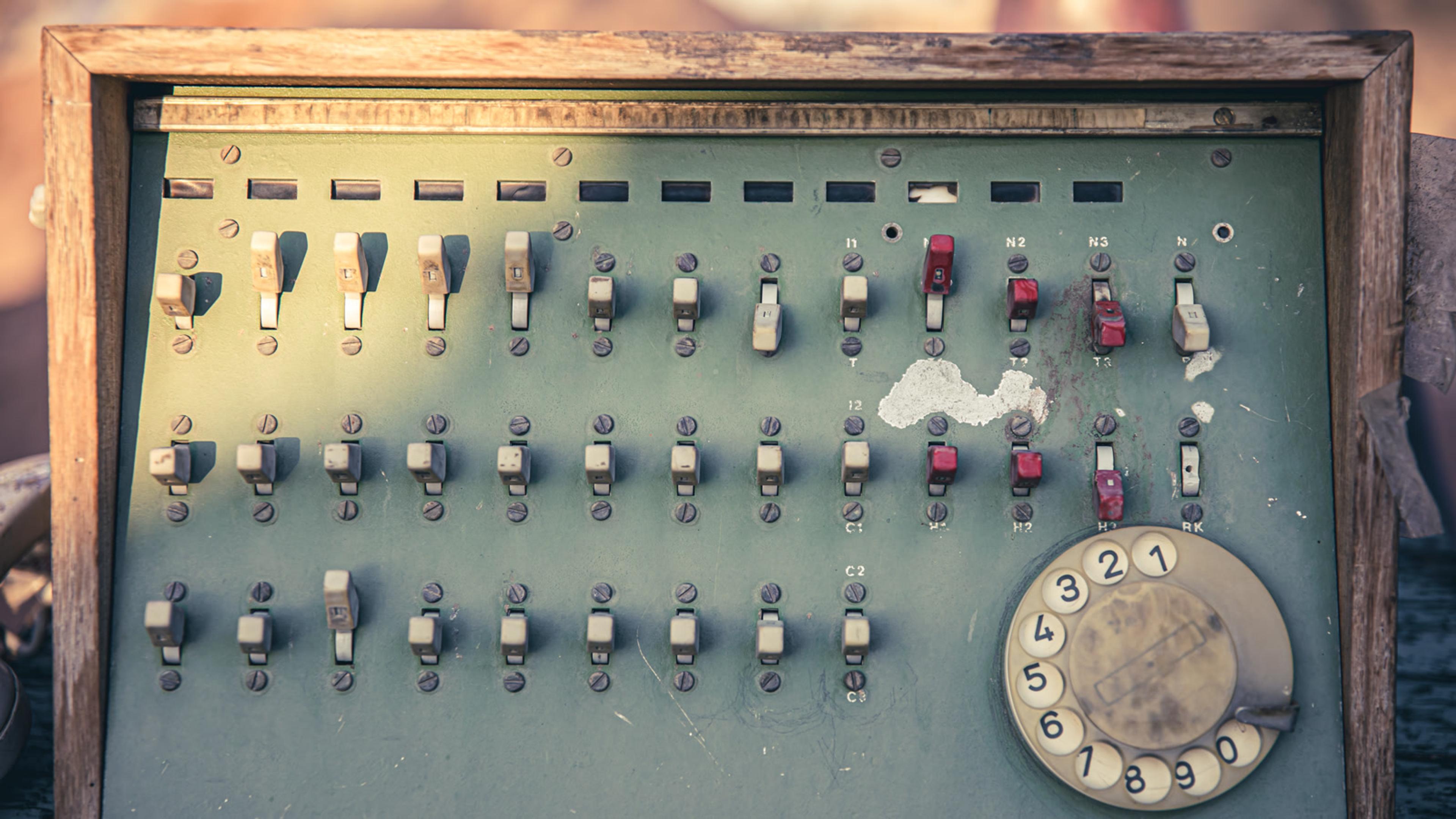 Vintage communications hub with switches and a rotary dial