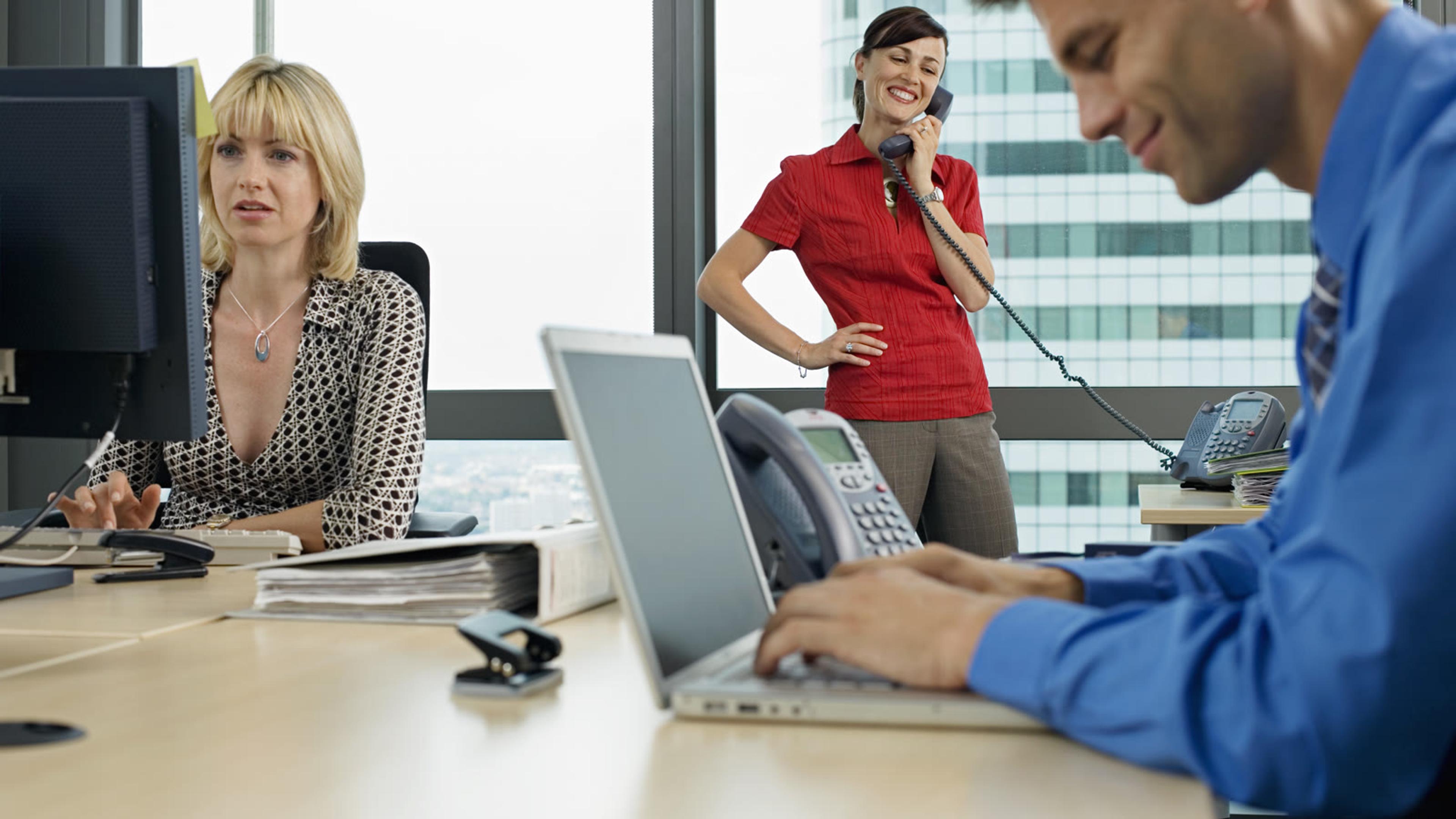 Busy professionals collaborating and taking calls in a modern office