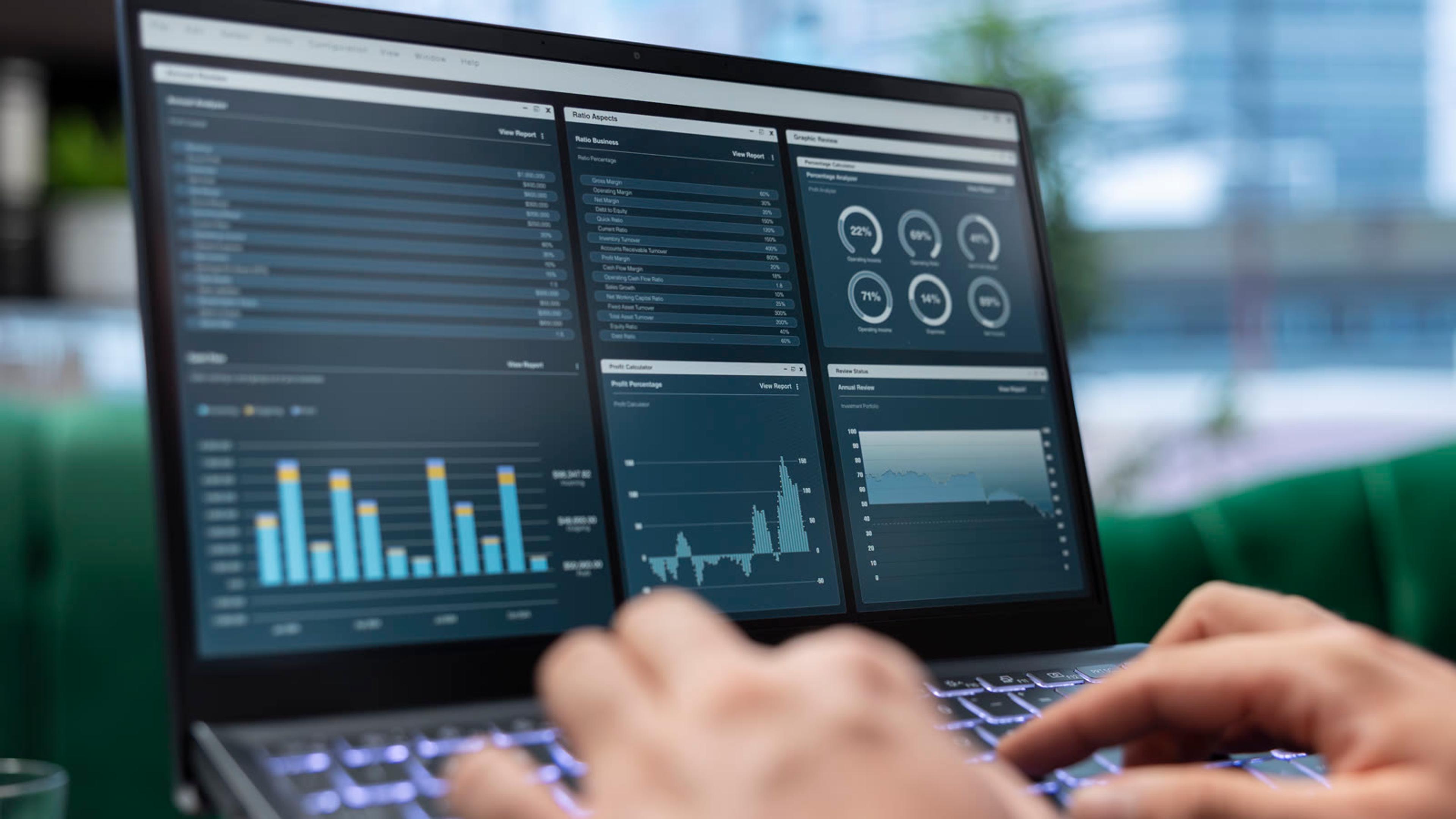IT professional reviewing network performance charts on a laptop