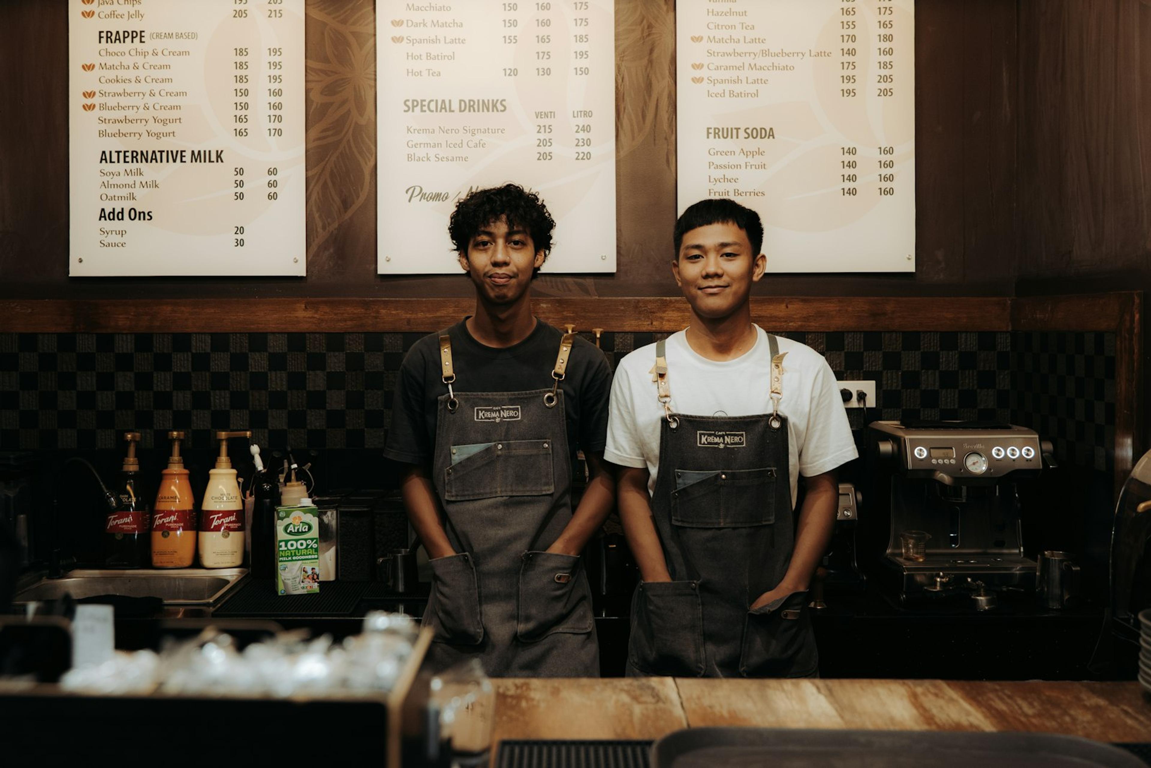 Two frontline small business team members serving customers together