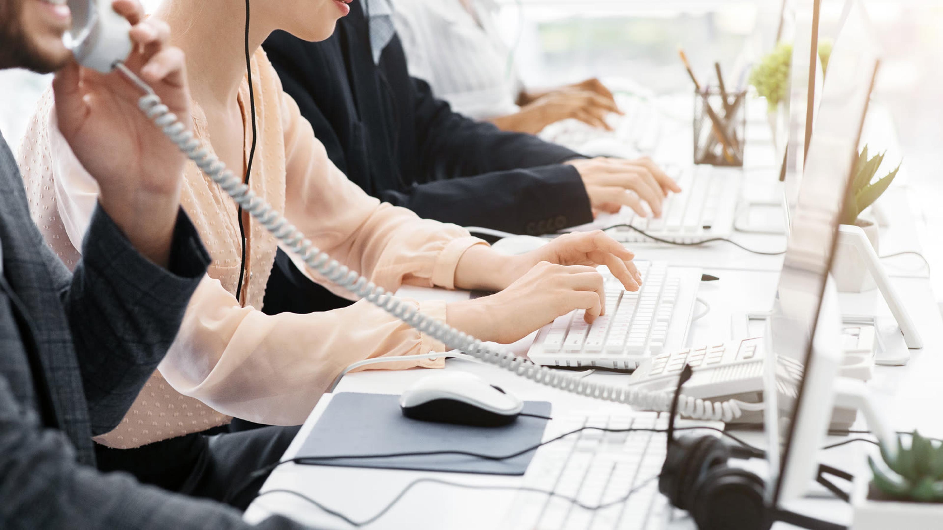 Office agents answering inbound calls together — simultaneous ring group covering a small business team