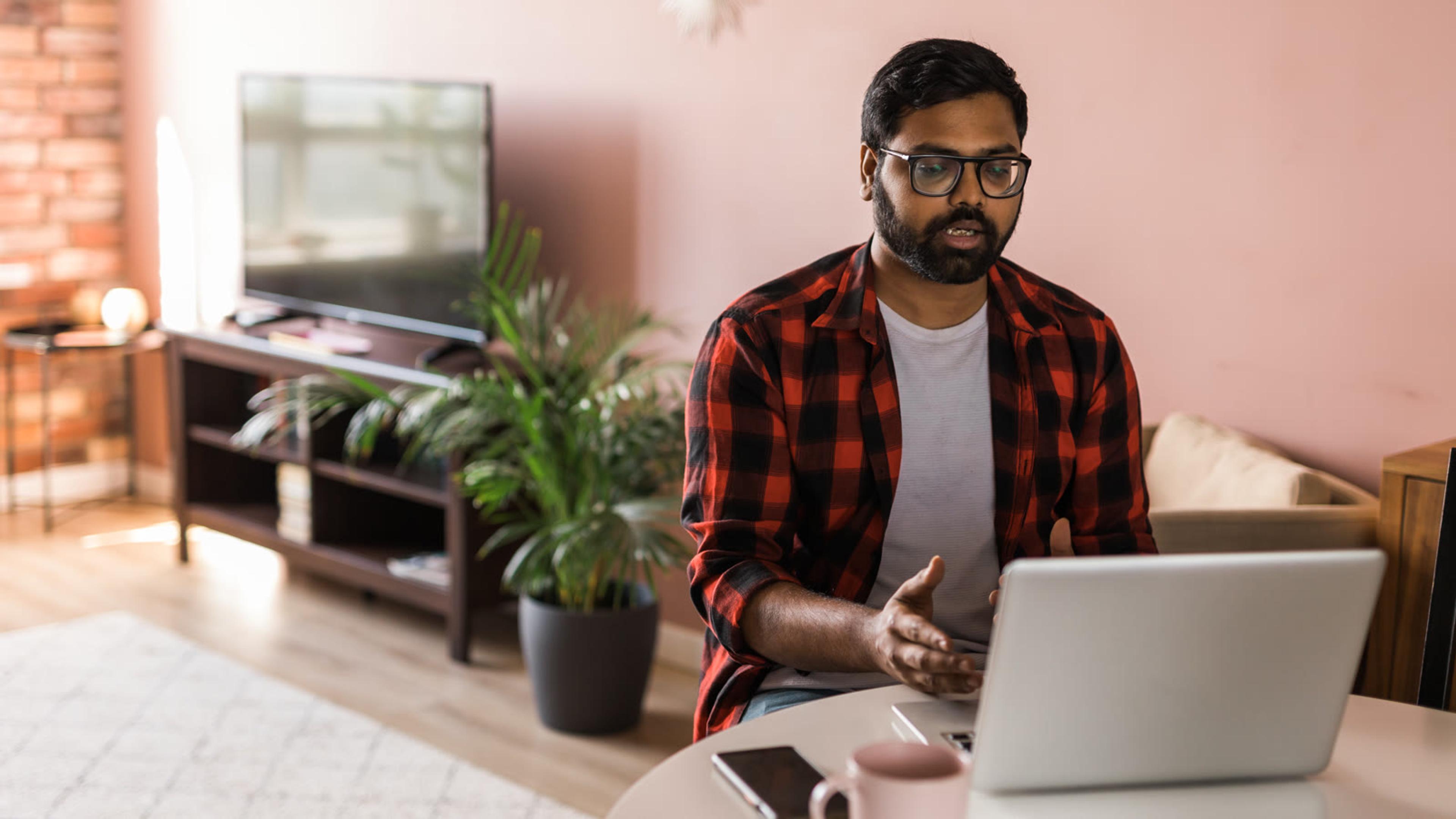 IT professional working on a laptop — reviewing help desk tickets and remote support requests