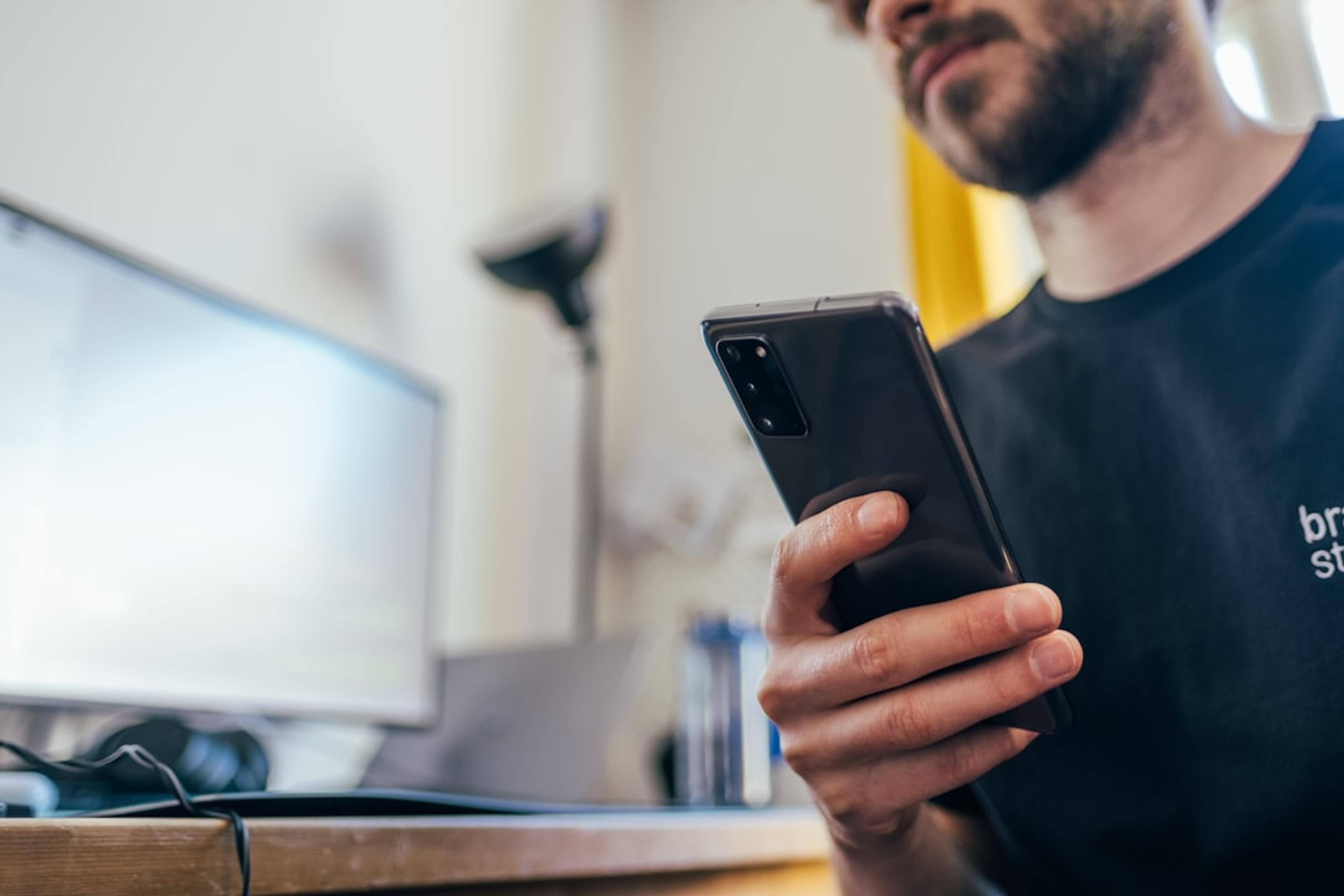 Business user holding a smartphone for mobile SIP softphone calling