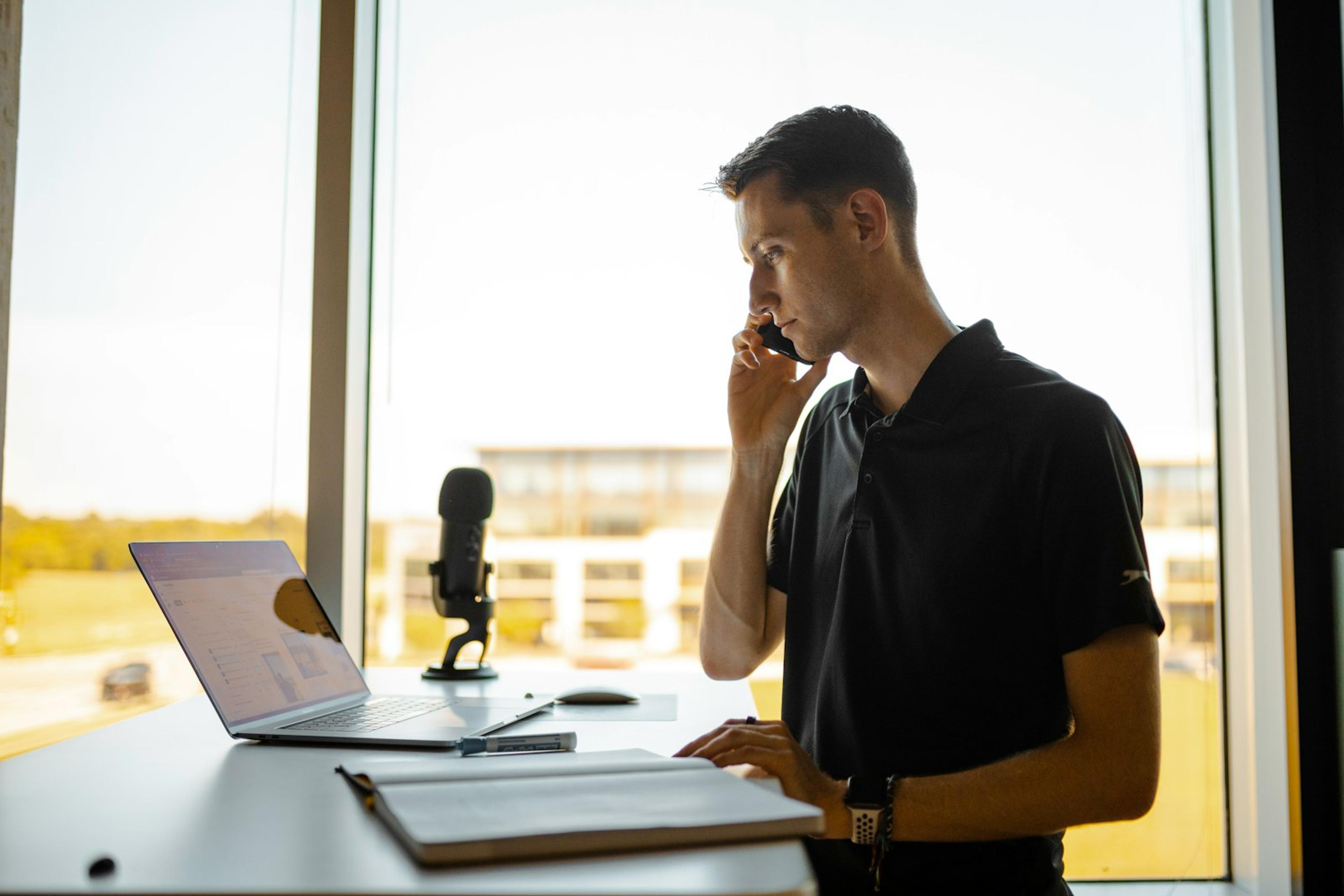 Business employee handling a customer phone call at a desk