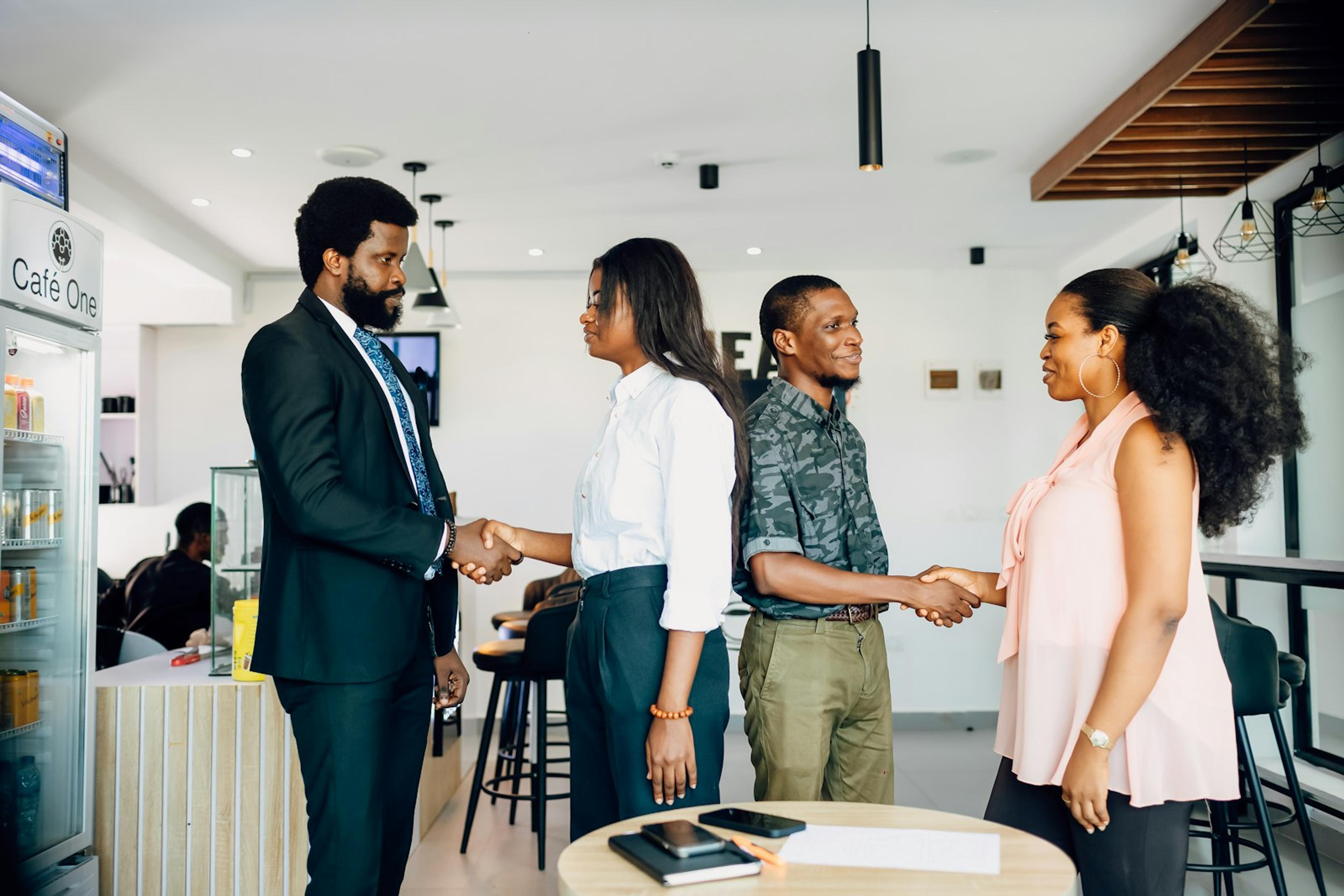 Business people completing a customer handoff with a handshake