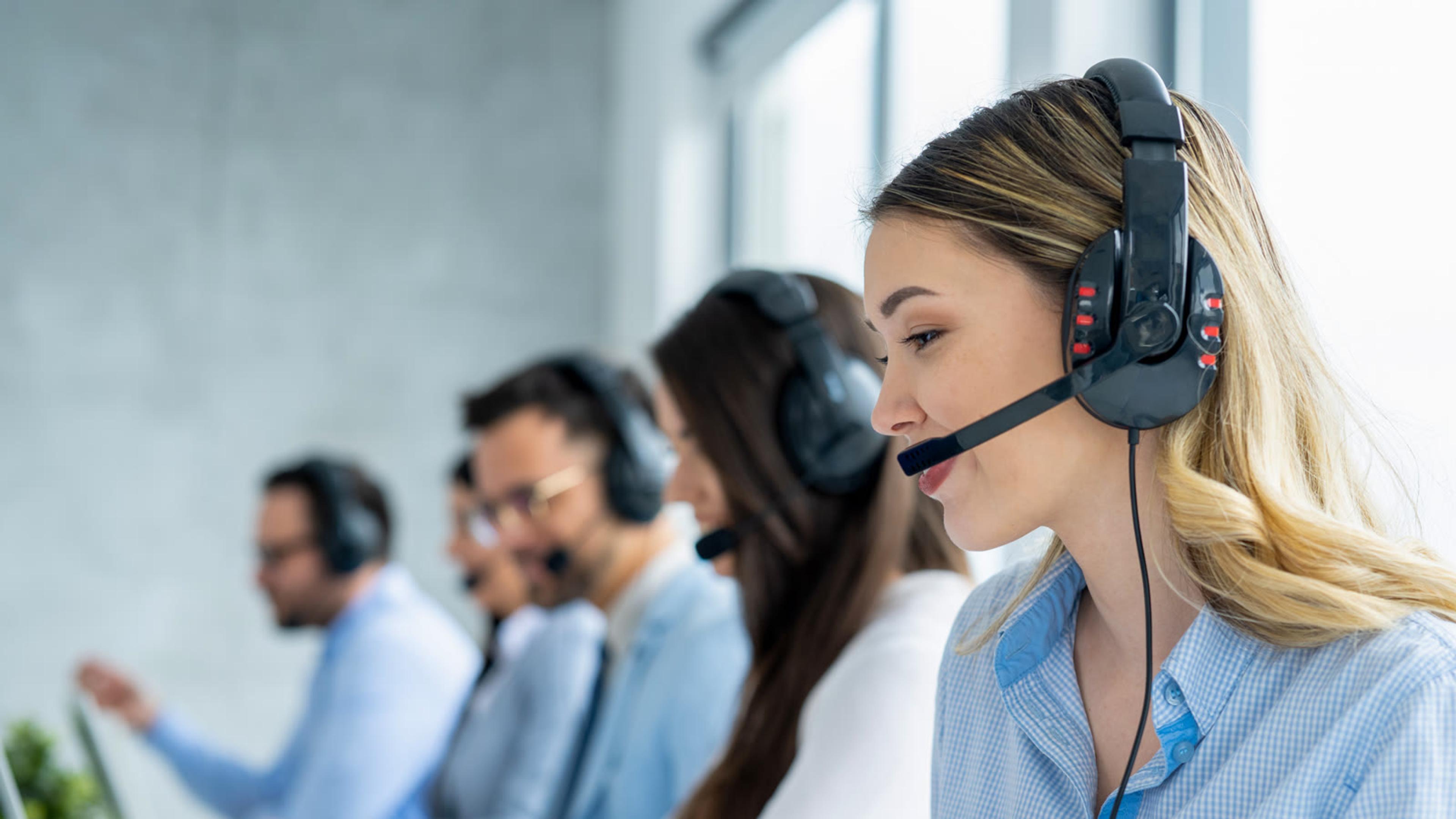 Support team with headsets handling customer calls for phone system and trunk issues