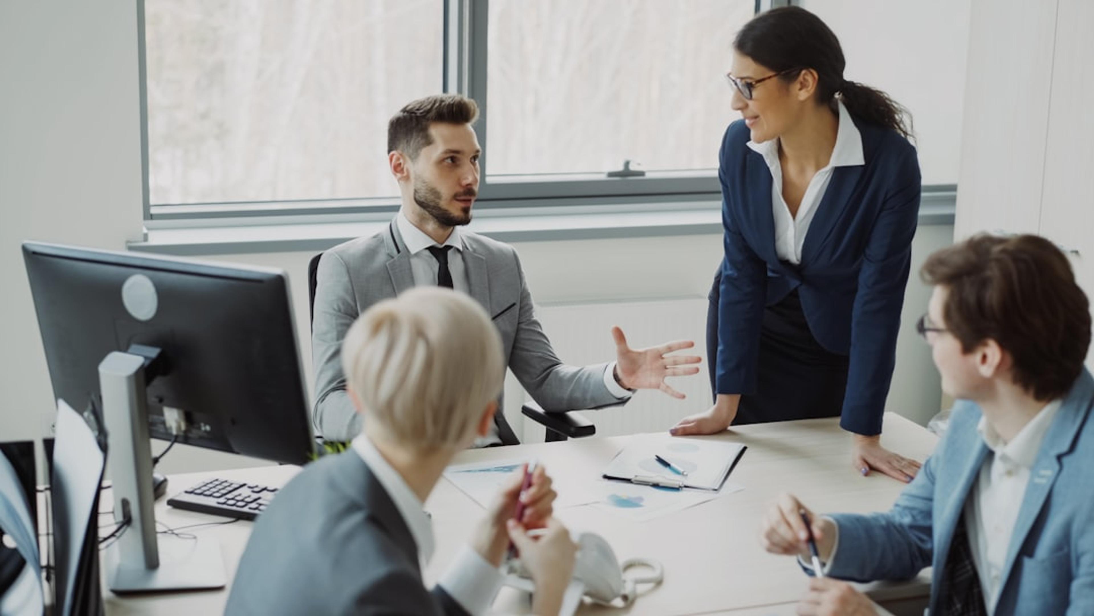 Business professionals collaborating in a modern open-plan office meeting