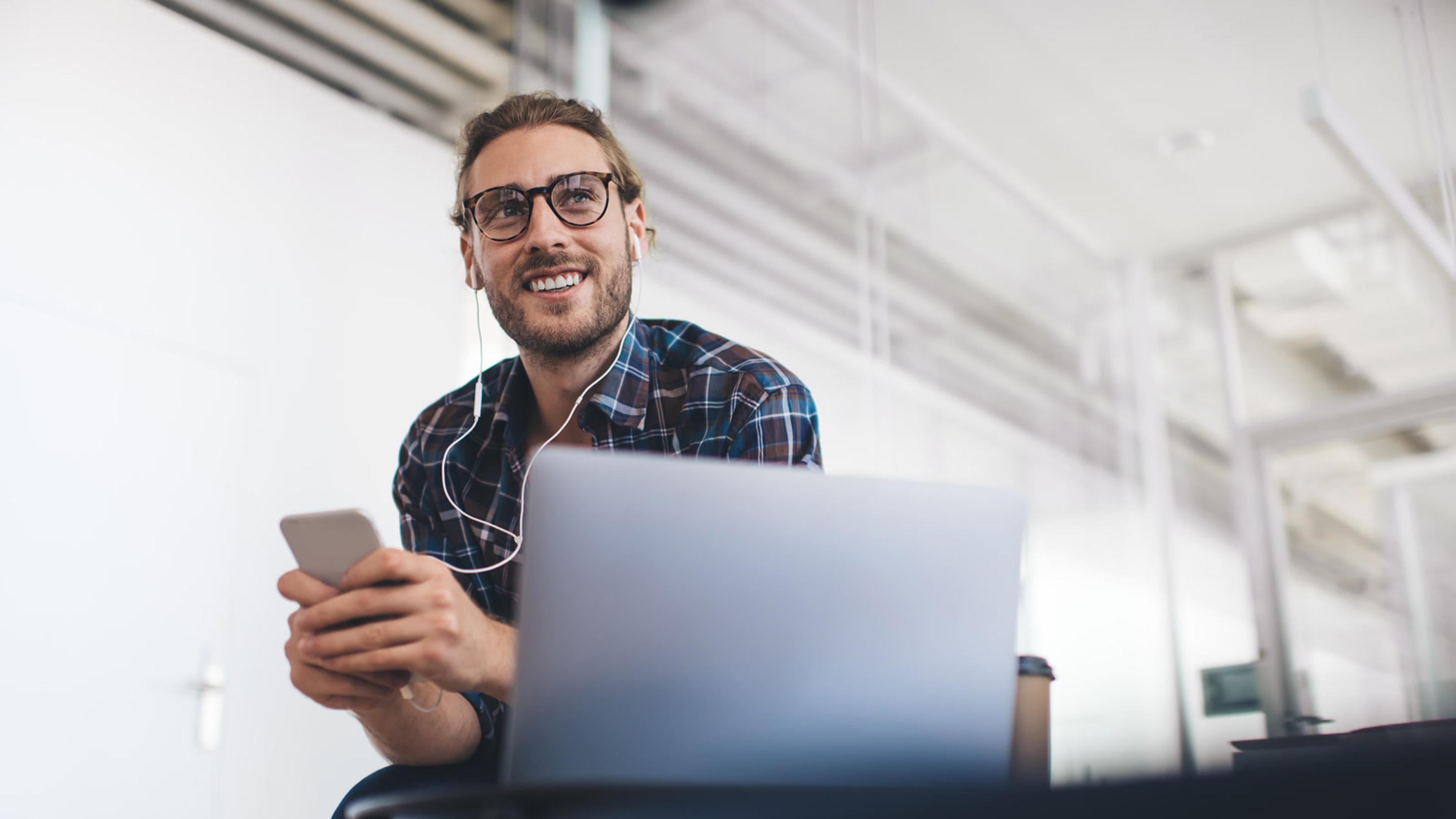New starter with a laptop and smartphone — day-one device onboarding and MFA