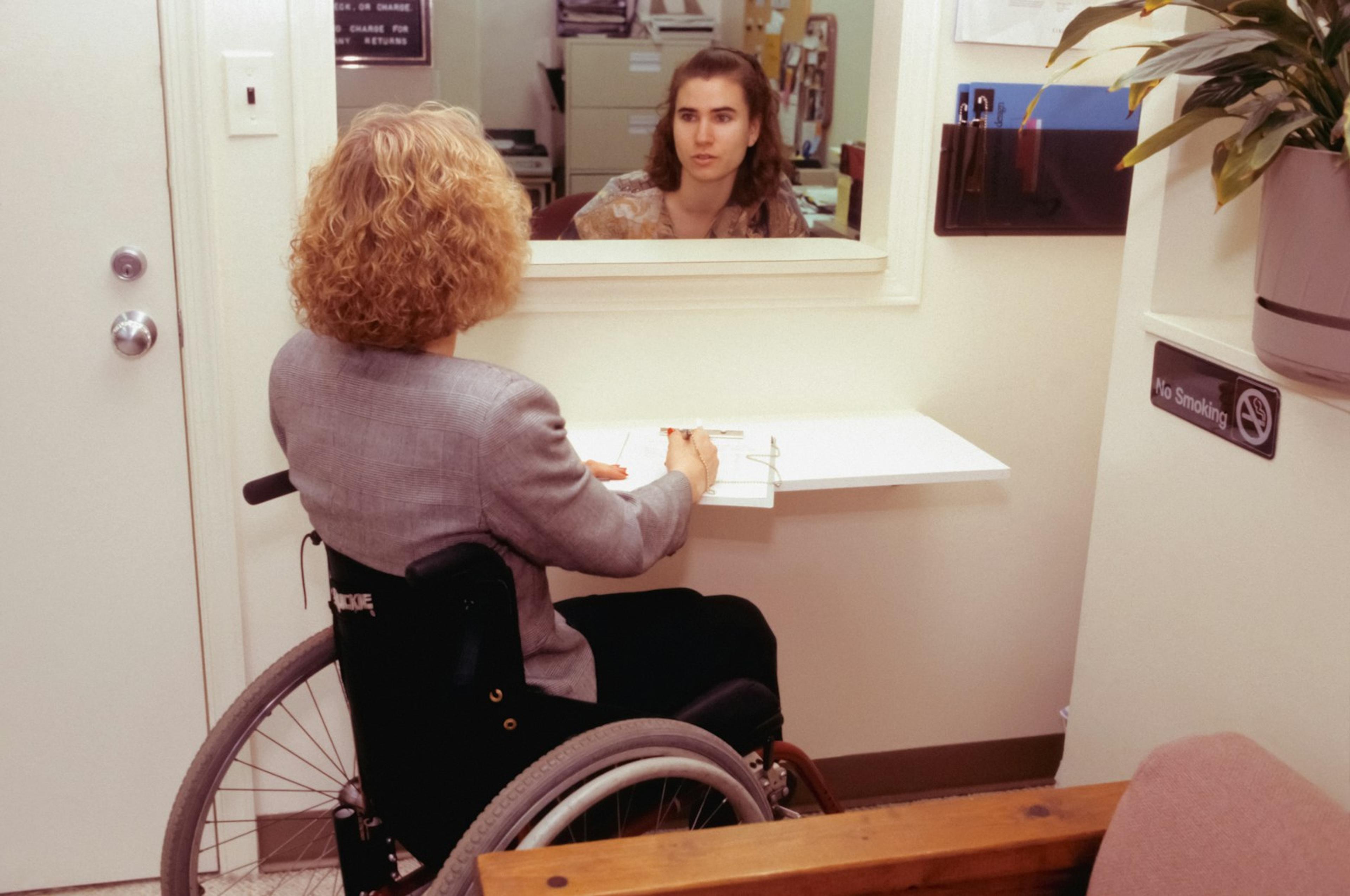 Patient and staff member at a healthcare reception desk