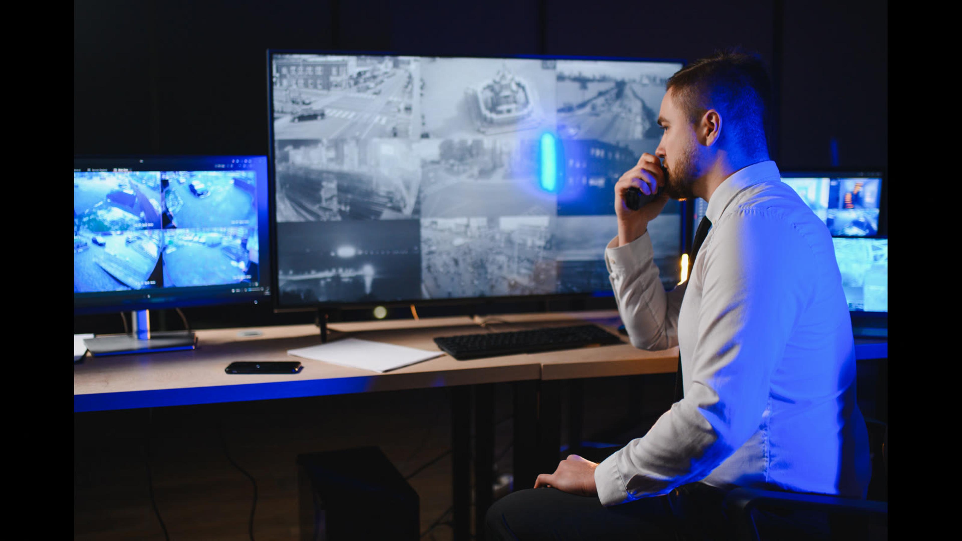 IT professional monitoring screens in a security control room — endpoint alert triage and console hygiene