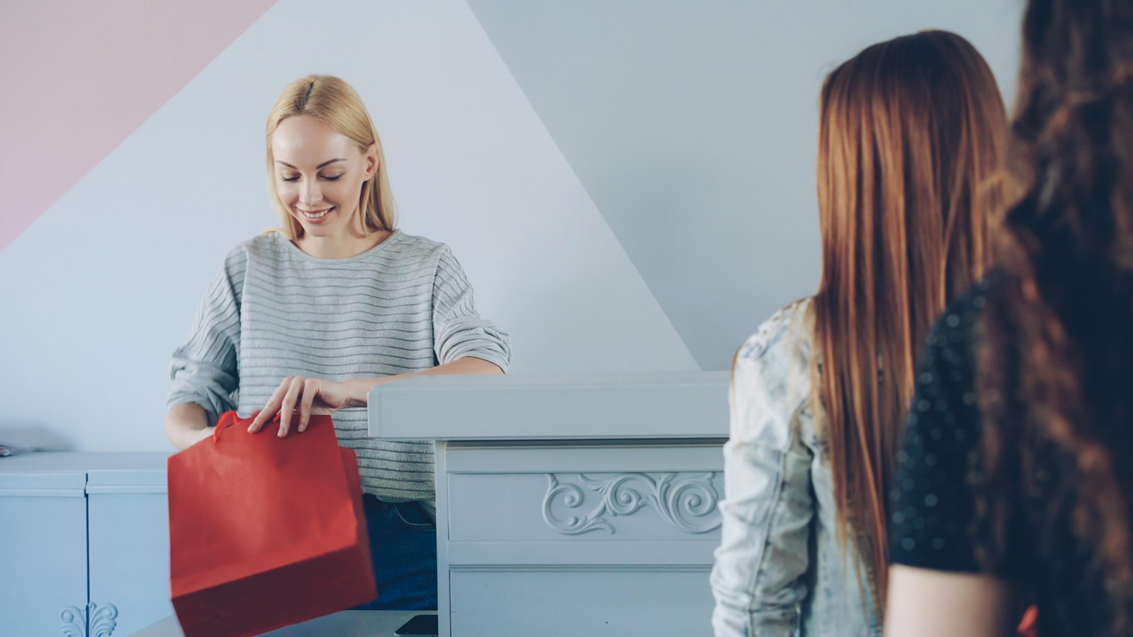 Retail employee helping a customer at a service counter