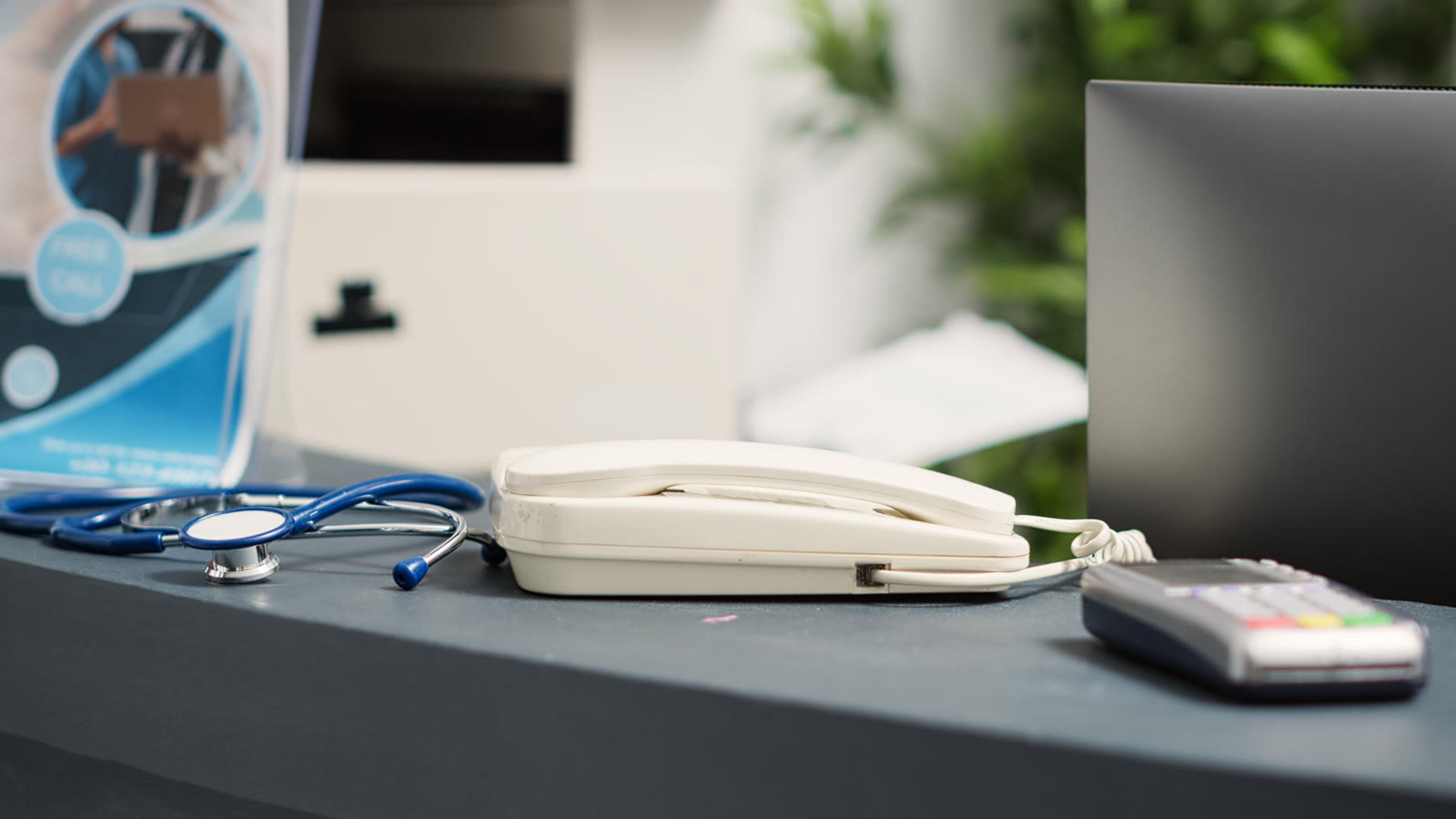 Medical equipment on a desk in a doctor office prepared for patient care calls