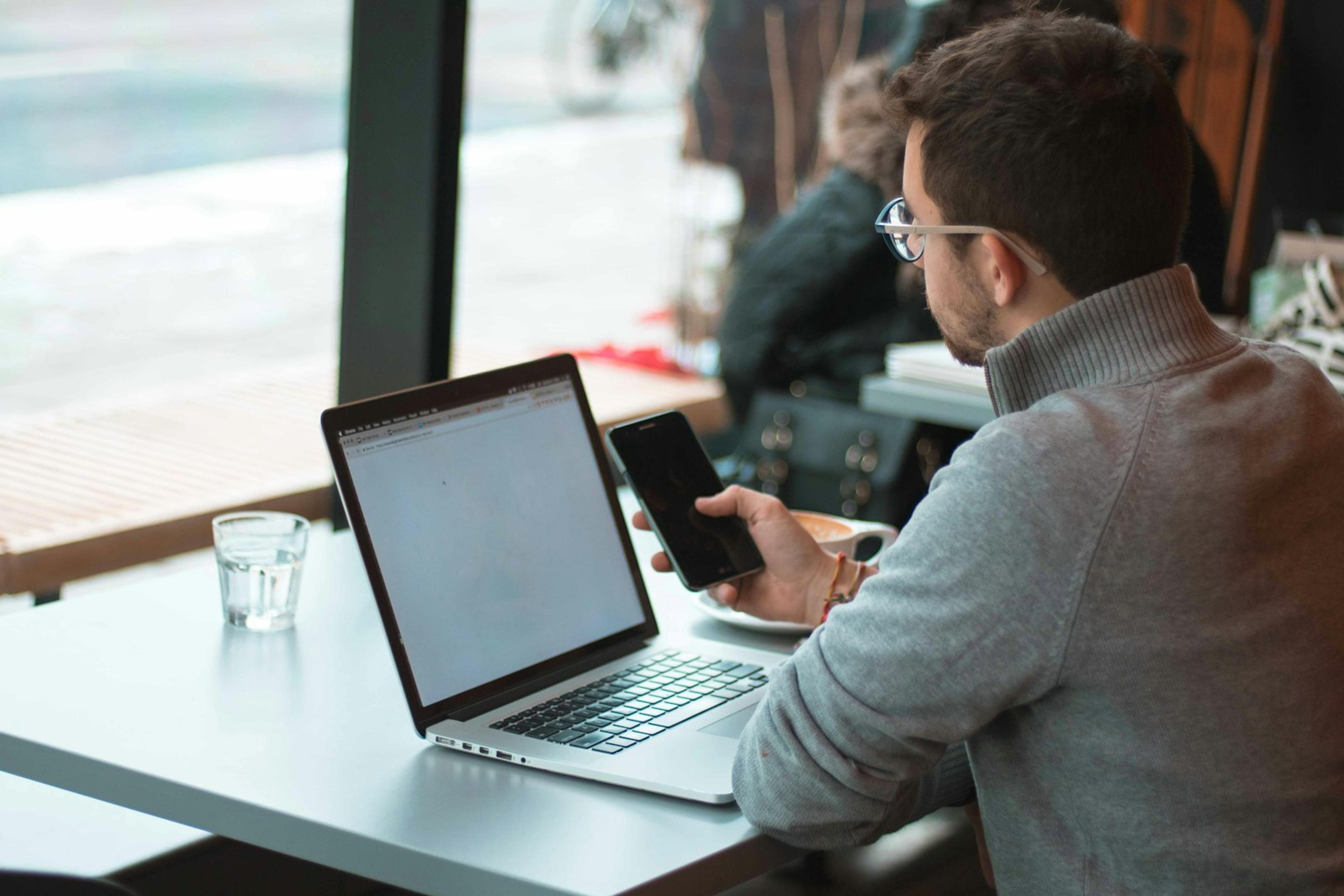 Business user working with a laptop and smartphone for desktop and mobile calling