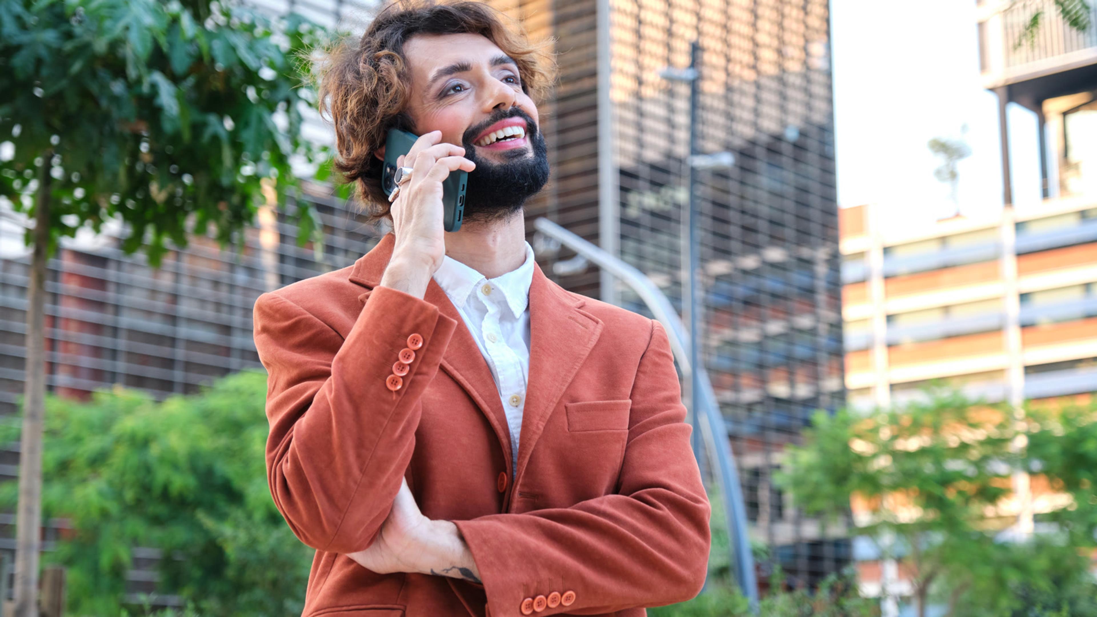 Person answering a forwarded business call on a mobile phone outdoors
