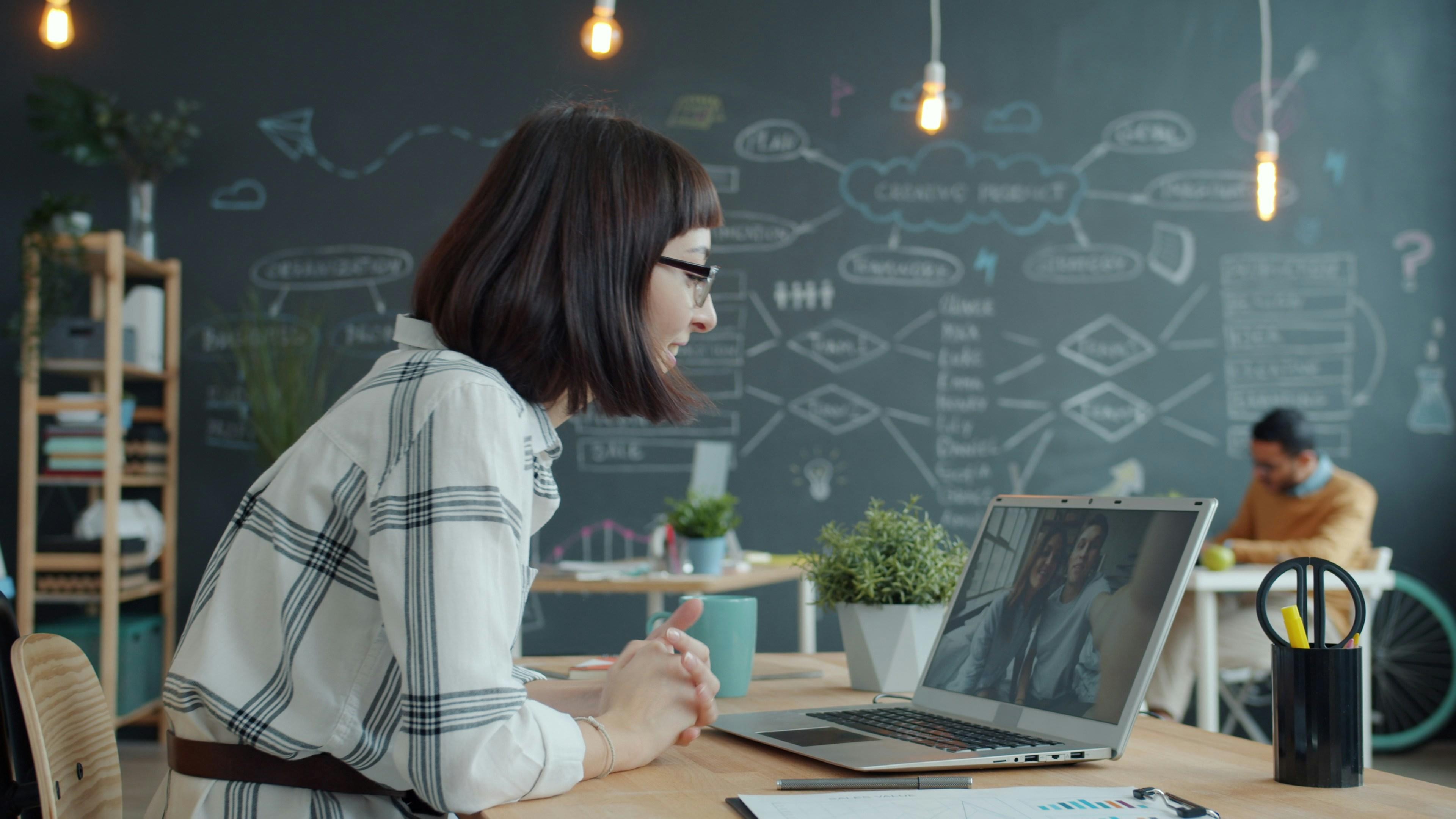 Business professional on video call in modern office, representing softphone communication in a secure workplace environment