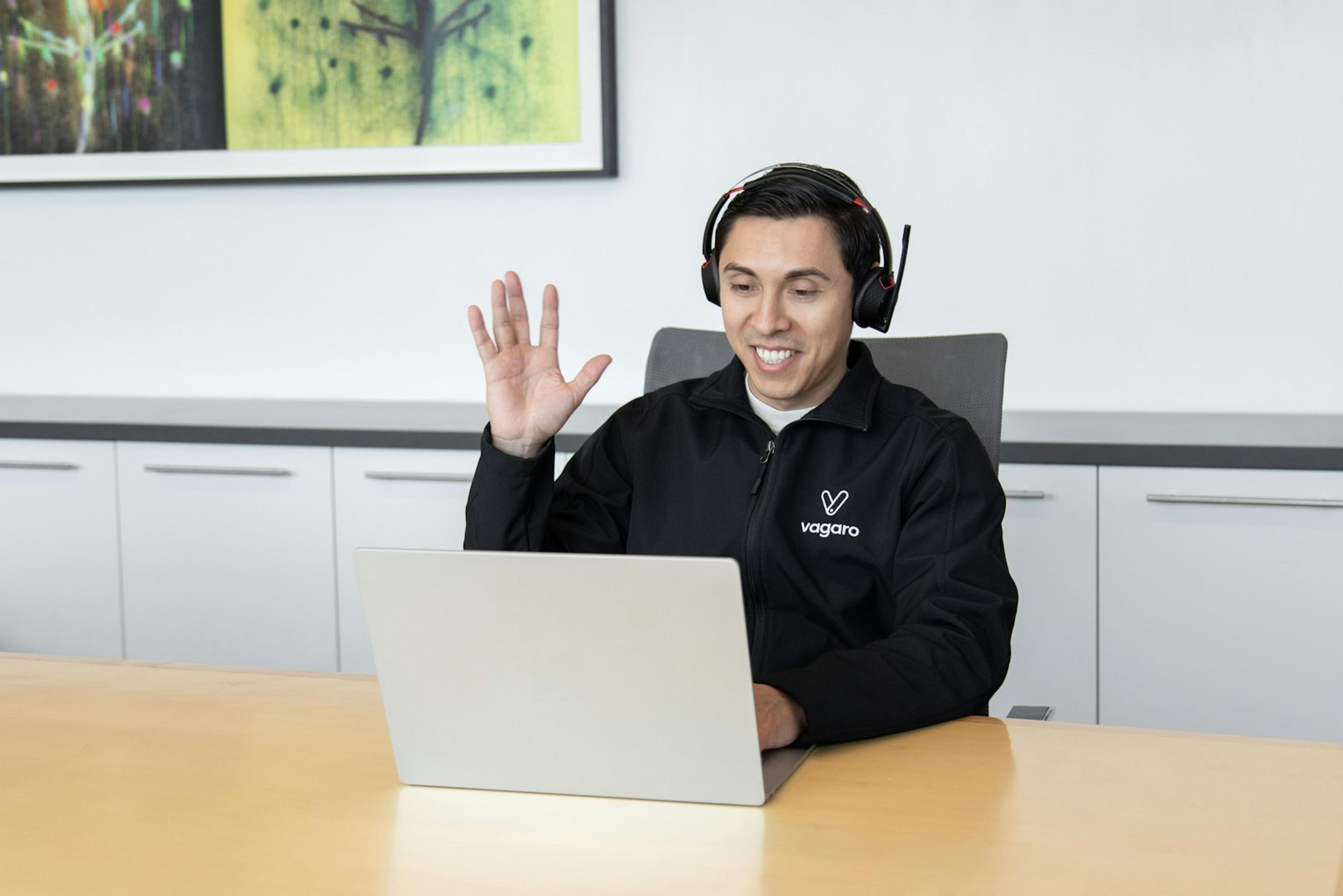 Customer support colleague using a headset and laptop