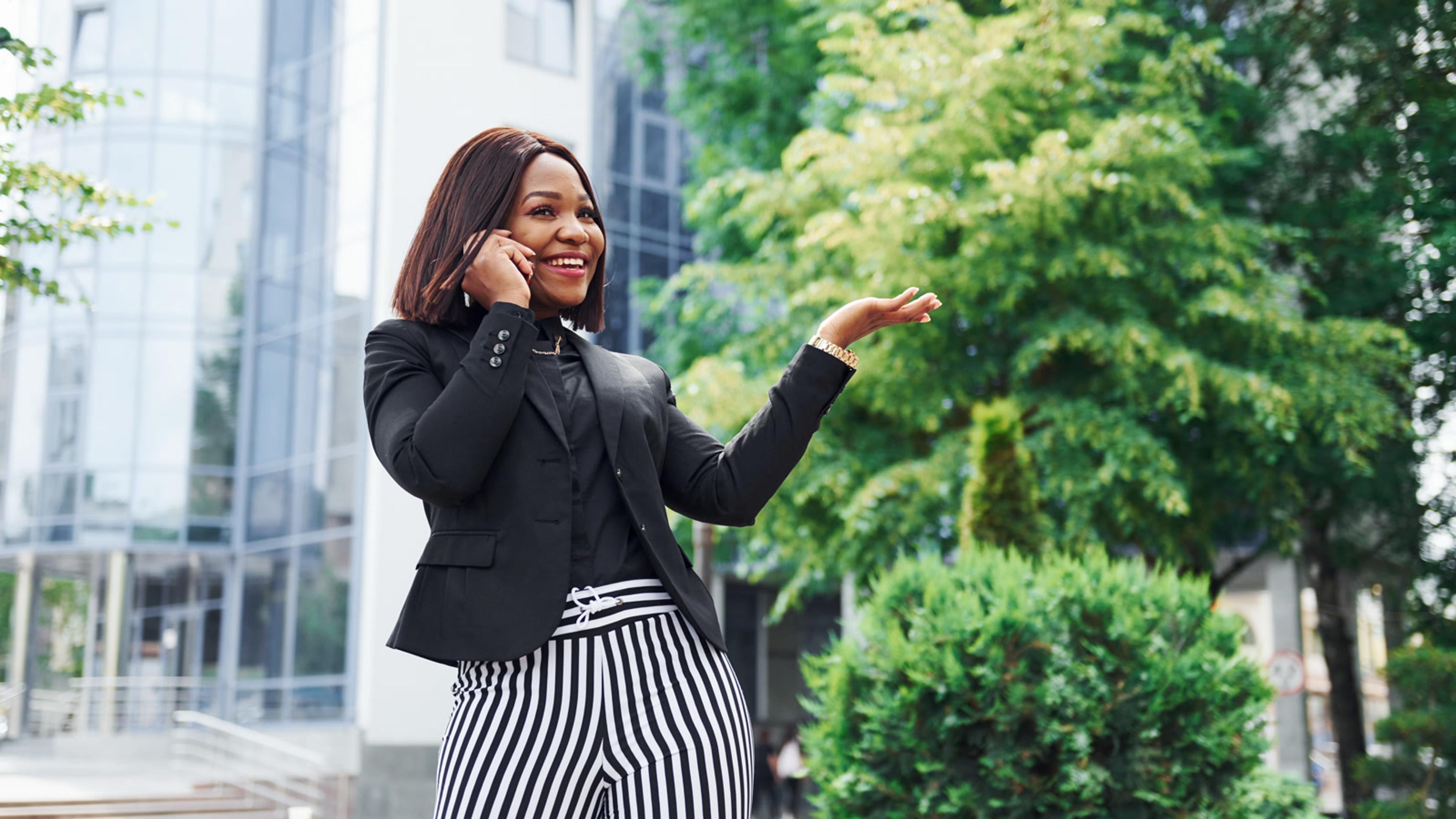 Woman in business attire talking on a cellphone — mobile softphone field test