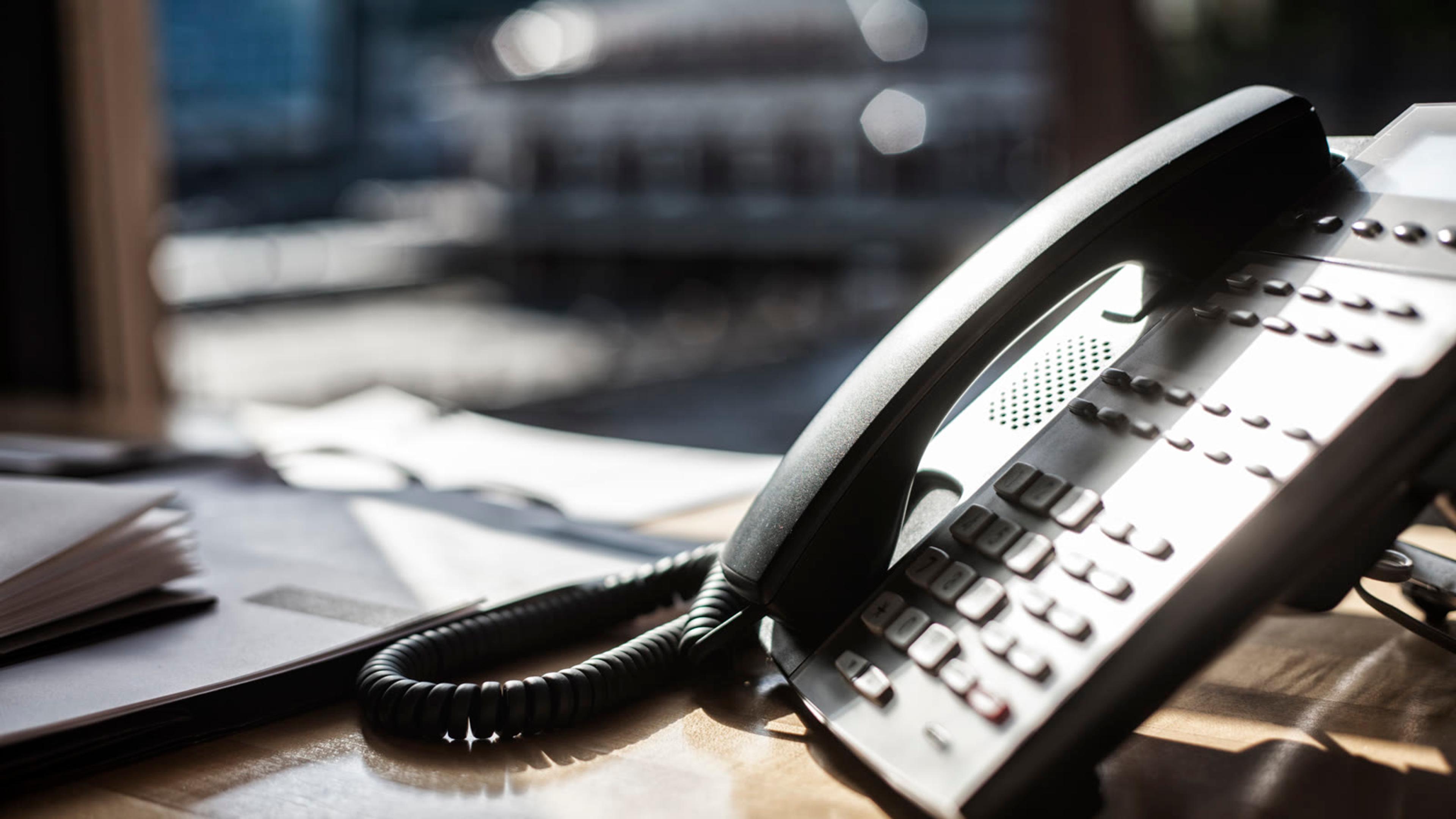 Business desk phone and handset on an office desk