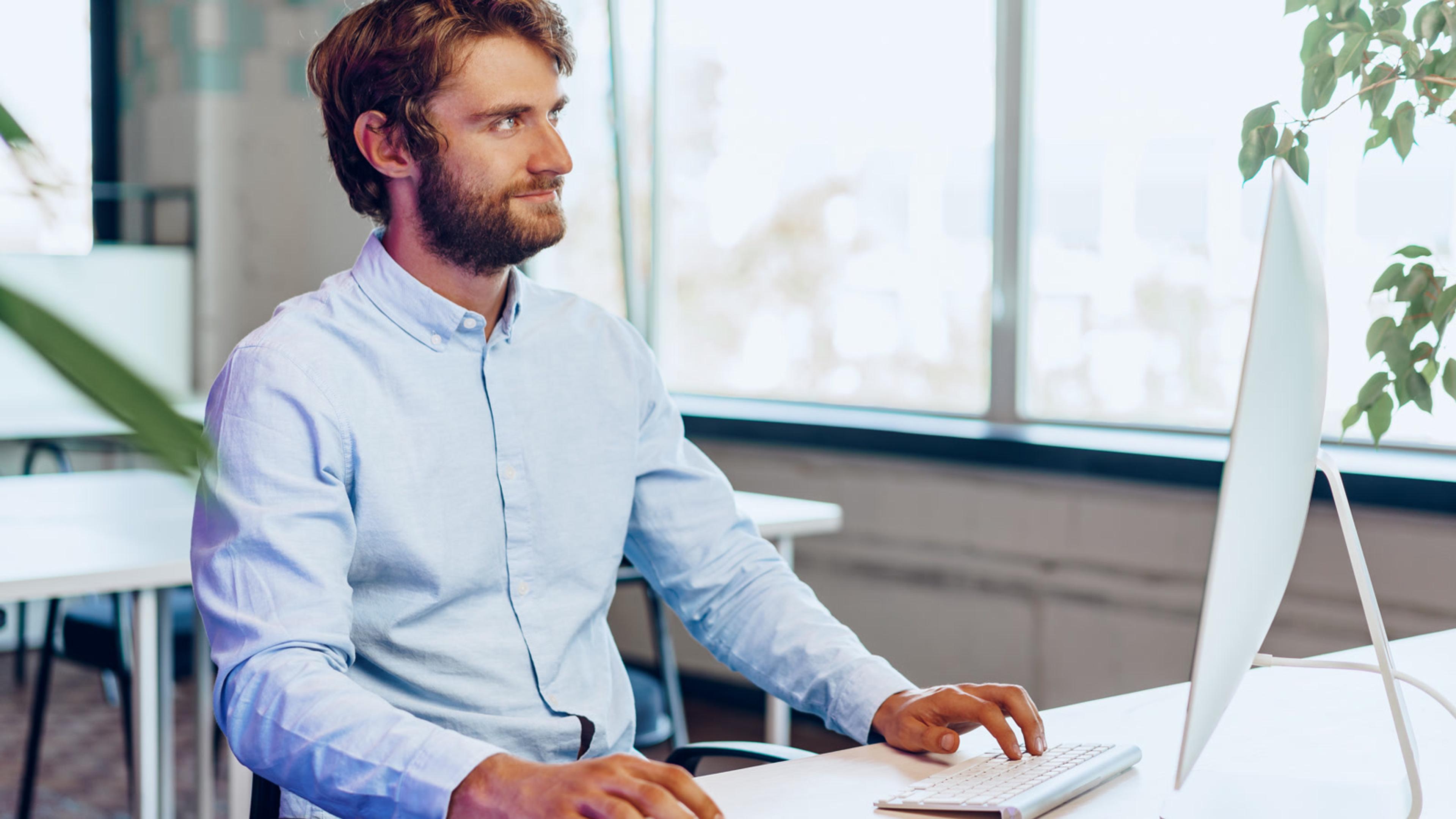 IT admin working at a computer configuring FreePBX softphone setup