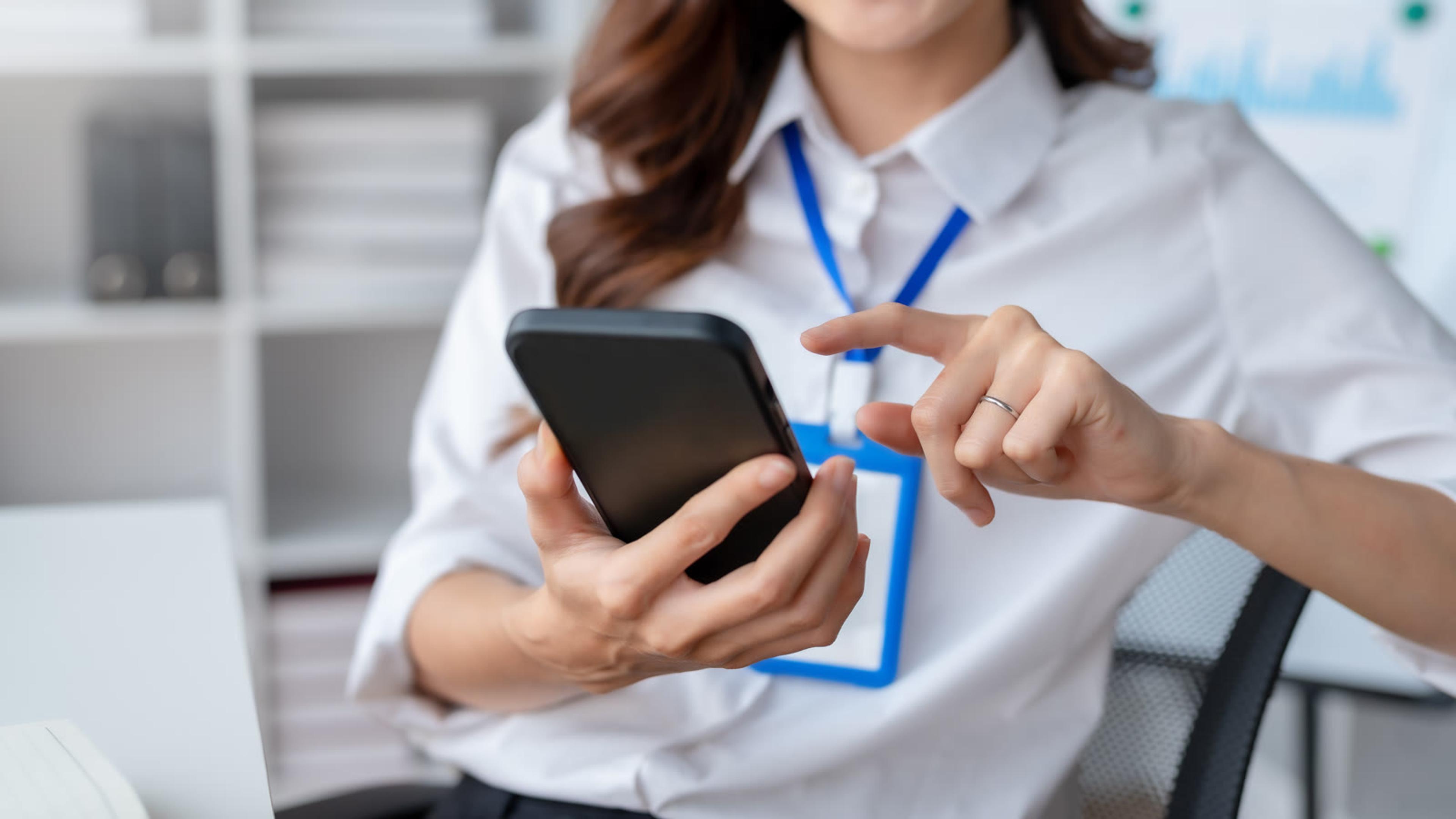 Office employee setting up the business softphone app on her smartphone