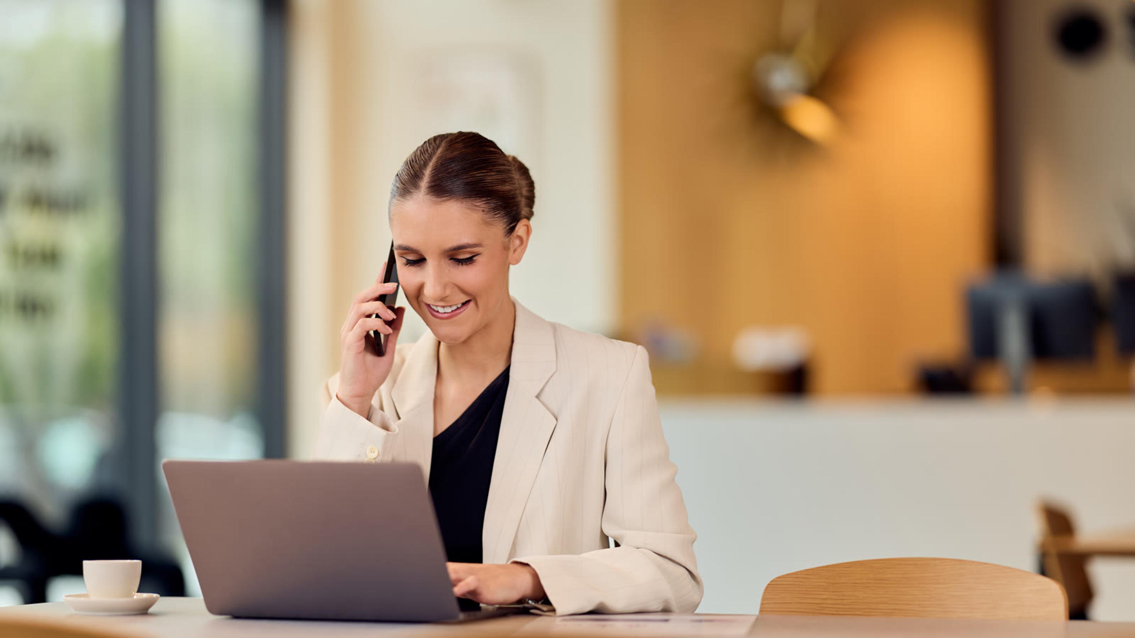 Consultant on a call at her laptop in a bright office, answering on one of several SIP accounts