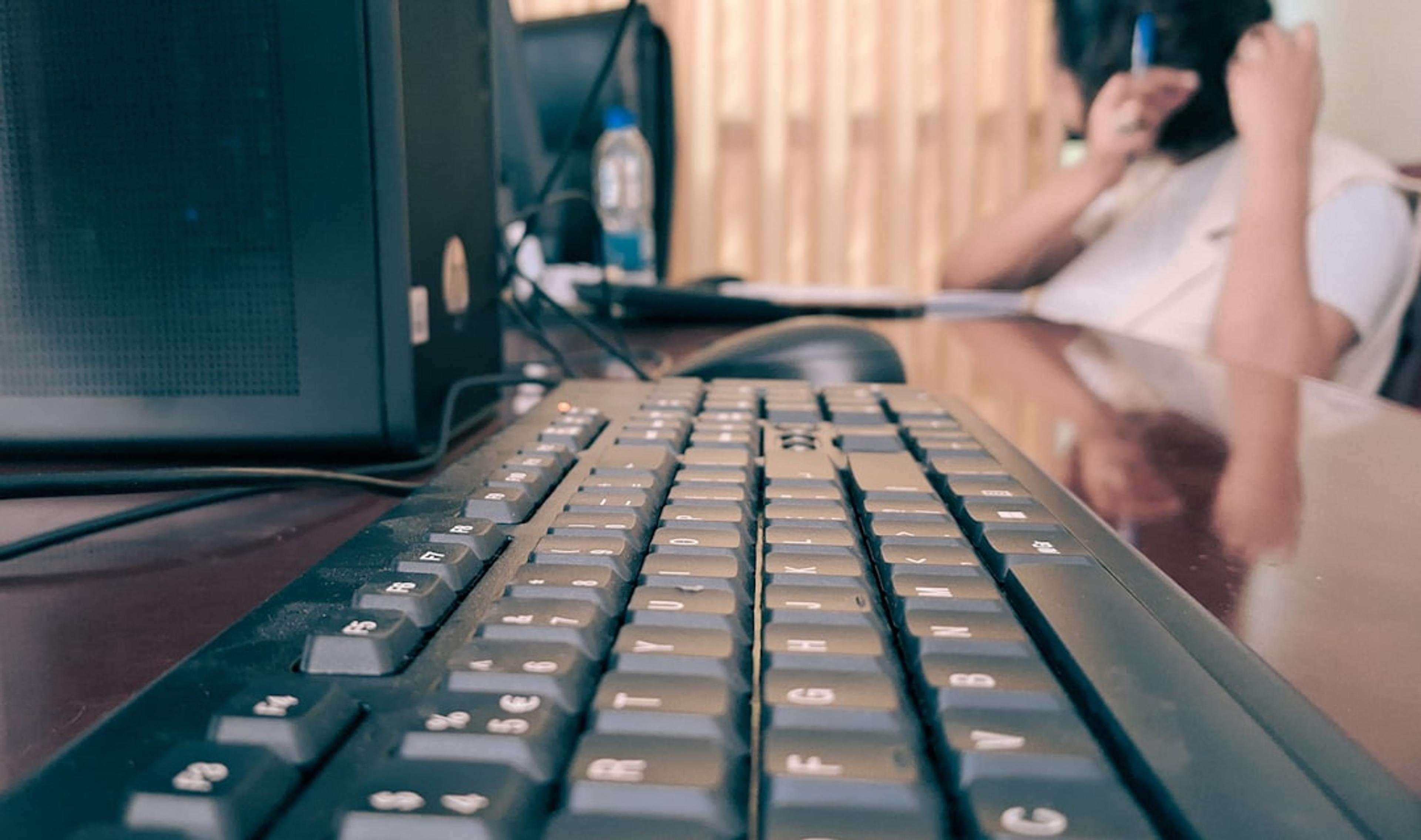 Office professional testing a reception calling workflow at a computer