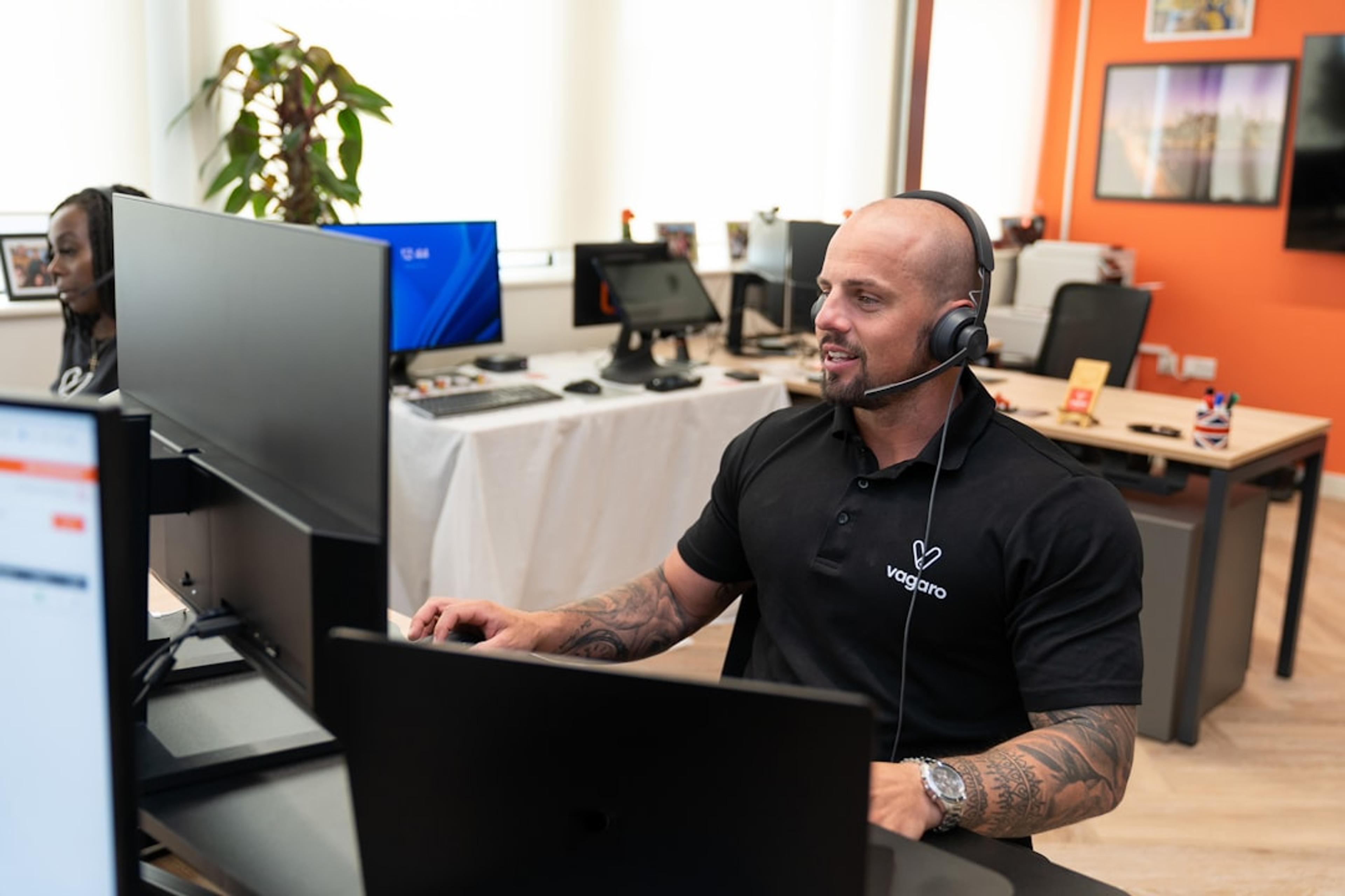 Support representative using a headset at a computer