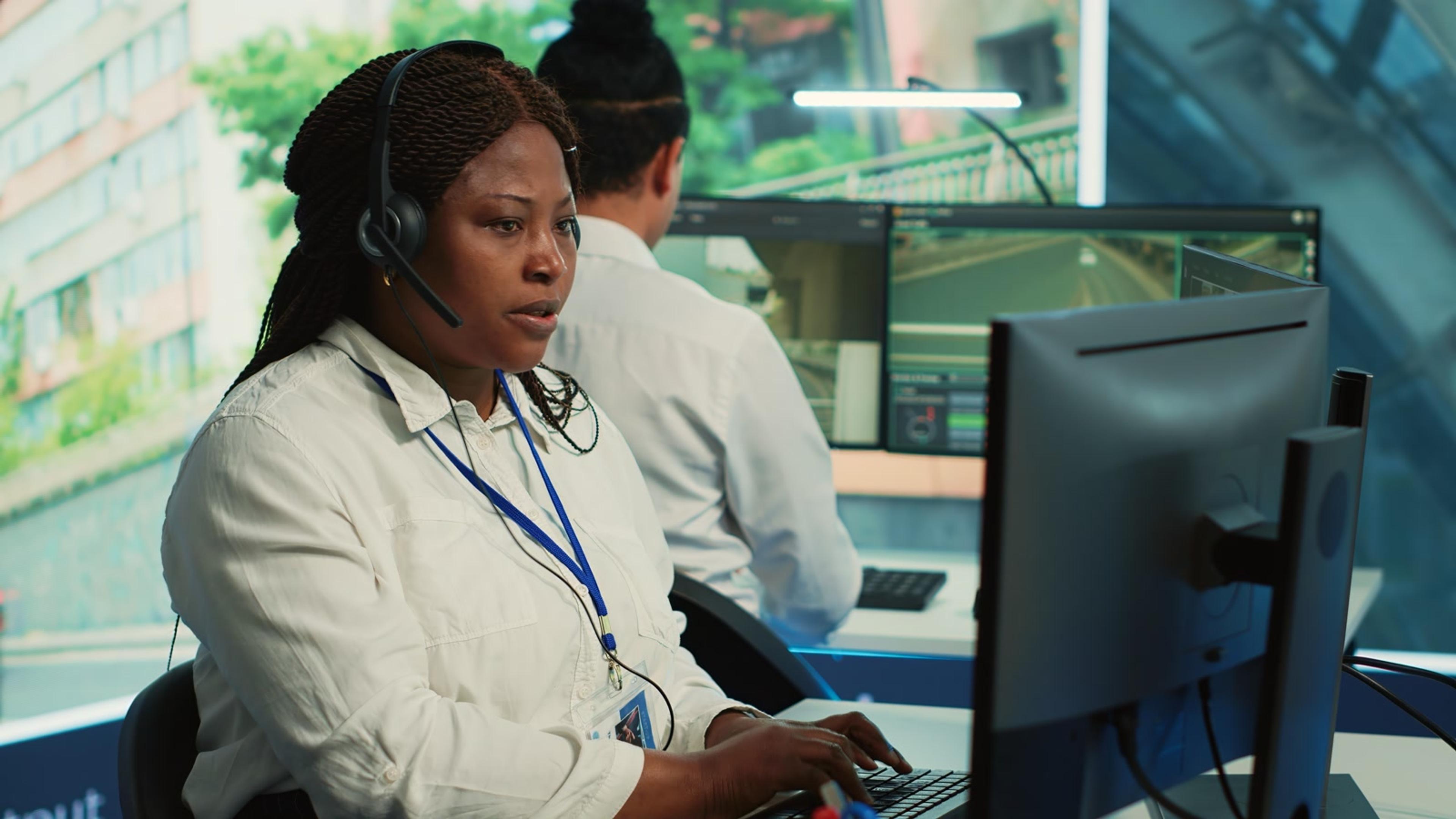 Focused woman working with a headset in a call center — MiVoice/MiCloud softphone replacement for teams