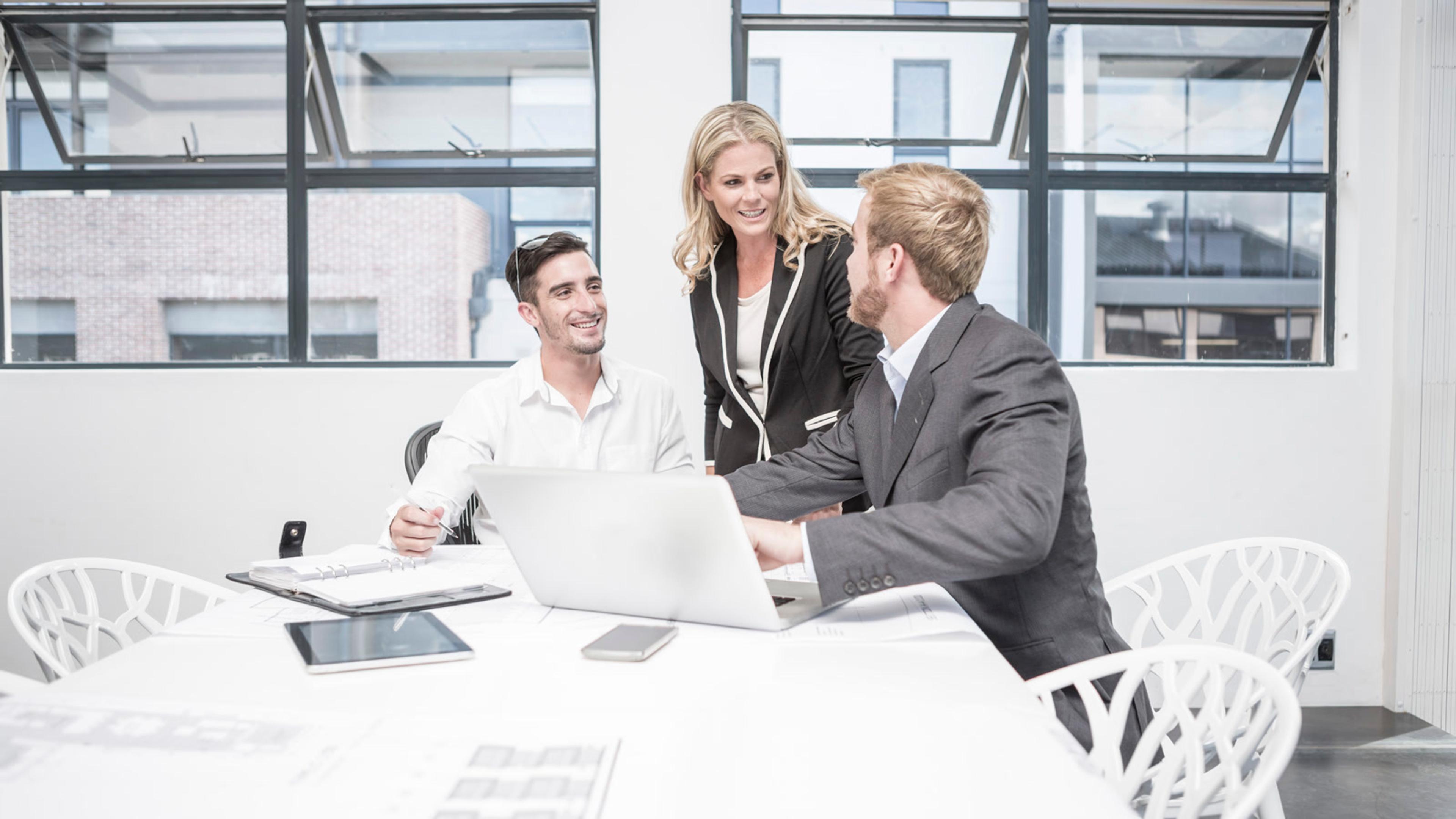 Business professionals discussing hosted voice packaging plans